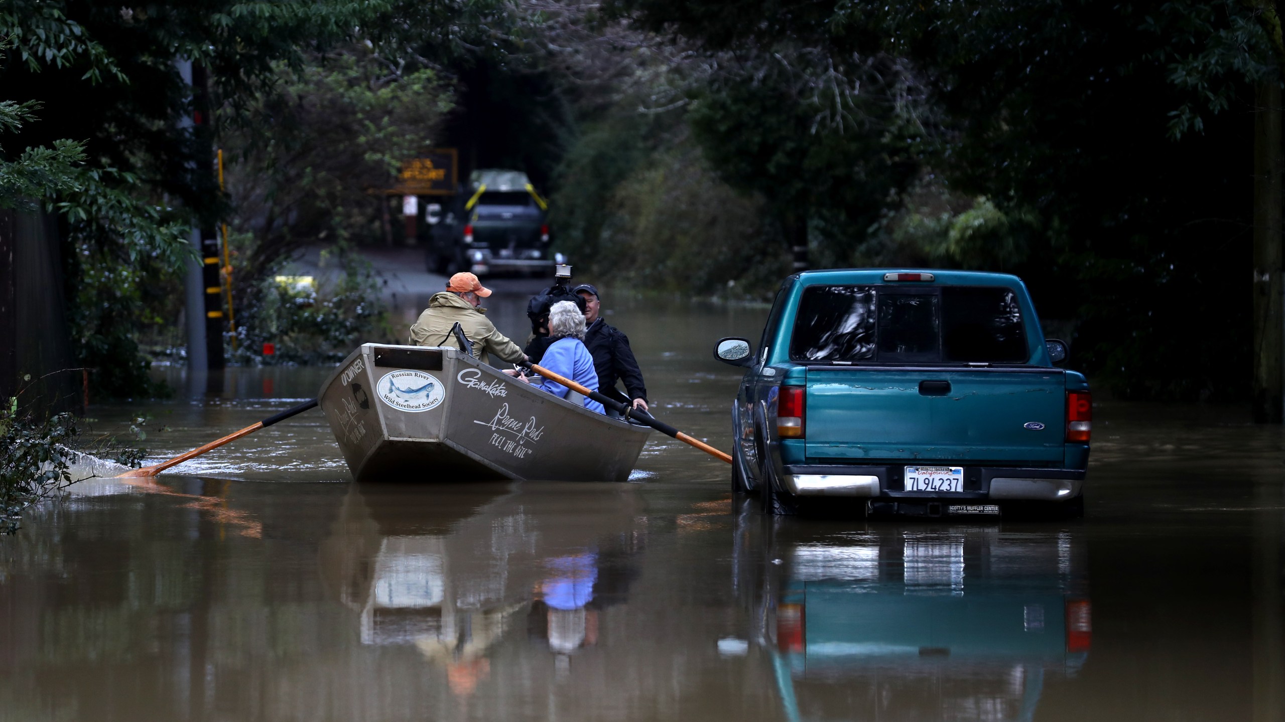 Residents use a boat to navigate floodwaters on Feb. 15, 2019 in Guerneville, Calif. An atmospheric river, a narrow corridor of concentrated moisture in the atmosphere, is bringing heavy rains to Northern California that is causing rivers to overflow their banks and flood many areas around the Russian River. (Credit: Justin Sullivan/Getty Images)