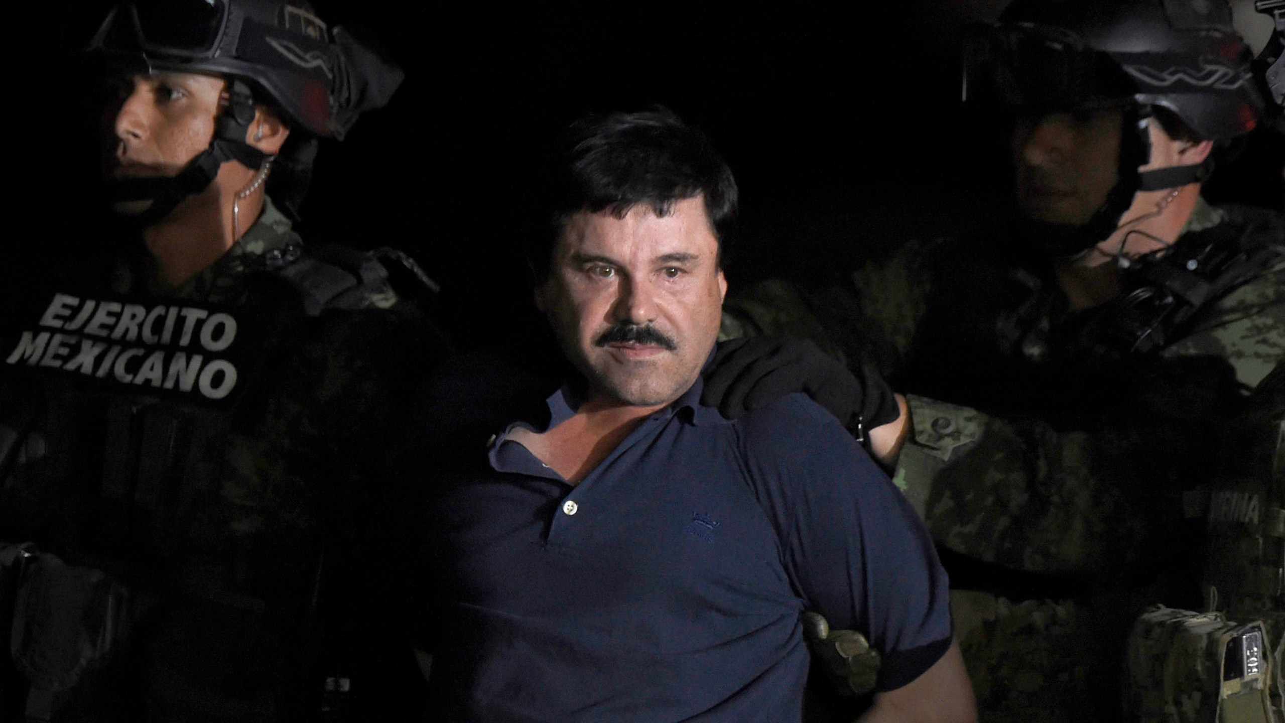 Joaquin "El Chapo" Guzman is escorted into a helicopter at Mexico City's airport on Jan. 8, 2016 following his recapture during an intense military operation in Los Mochis, in Sinaloa State. (Credit: ALFREDO ESTRELLA/AFP/Getty Images)