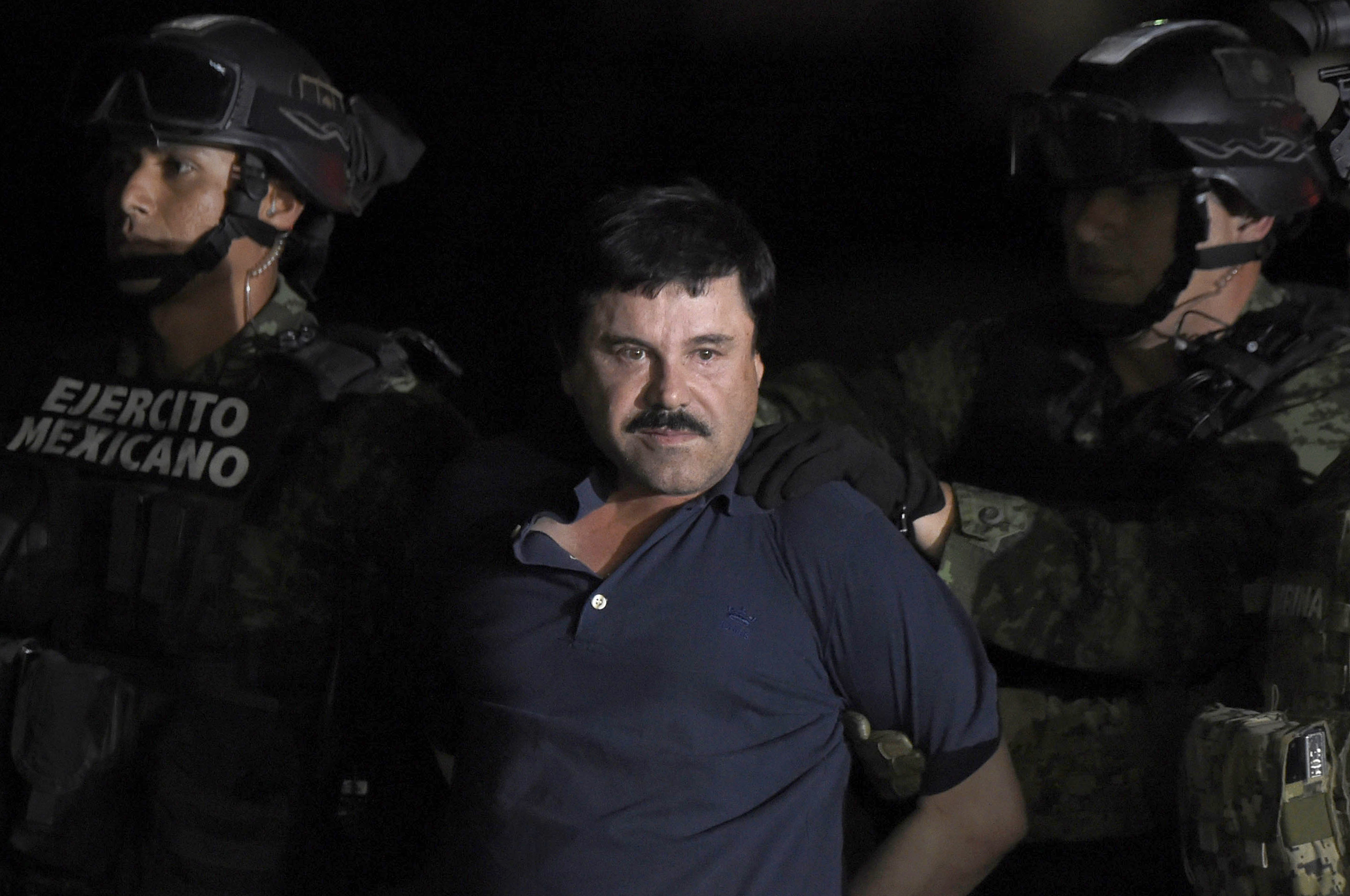 Joaquin "El Chapo" Guzman is escorted into a helicopter at Mexico City's airport on Jan. 8, 2016 following his recapture during an intense military operation in Los Mochis, in Sinaloa State. (Credit: ALFREDO ESTRELLA/AFP/Getty Images)