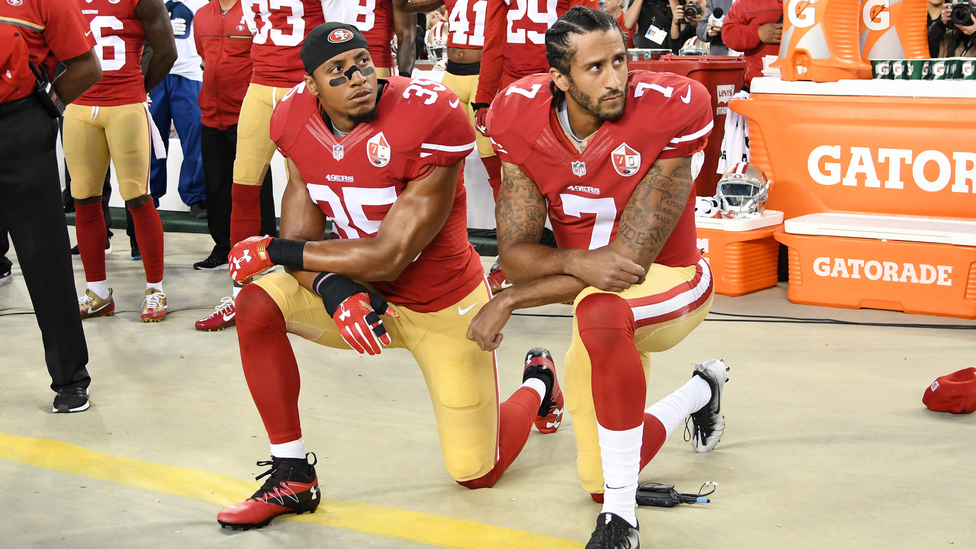 Colin Kaepernick #7 and Eric Reid #35 of the San Francisco 49ers kneel in protest during the national anthem prior to playing the Los Angeles Rams in their NFL game at Levi's Stadium on September 12, 2016 in Santa Clara. (Credit: Thearon W. Henderson/Getty Images)