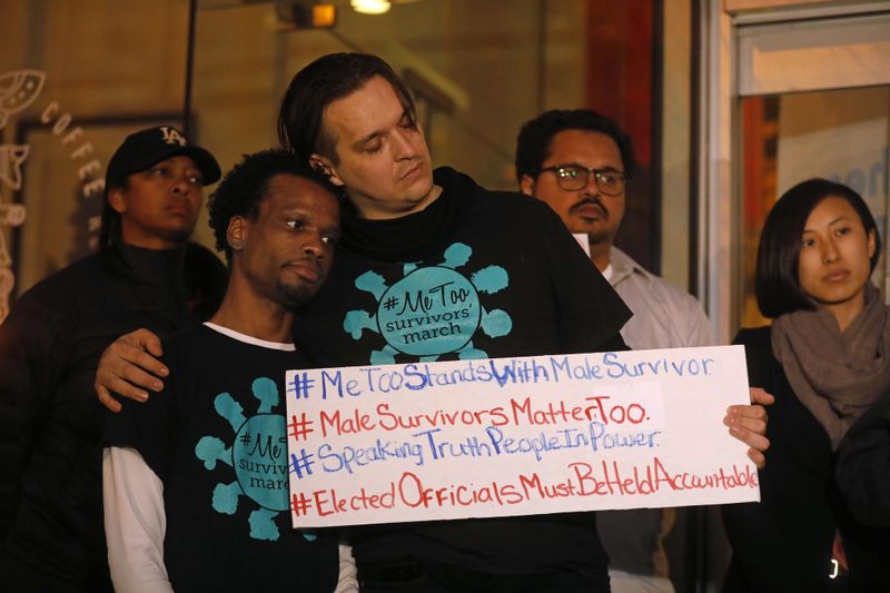 Jerome Kitchen, left, gets a hug of support from Steven Martin, while others outside the West Hollywood City Council chambers to call on West Hollywood Mayor John Duran to resign amid allegations of sexual harassment on Feb. 19, 2019. (Credit: Genaro Molina / Los Angeles Times)