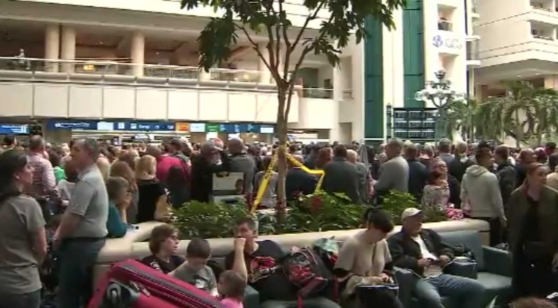 Travelers are seen at Orlando International Airport after a TSA officer jumped to his death on Feb. 2, 2019. (Credit: WFTV/Cox via CNN)