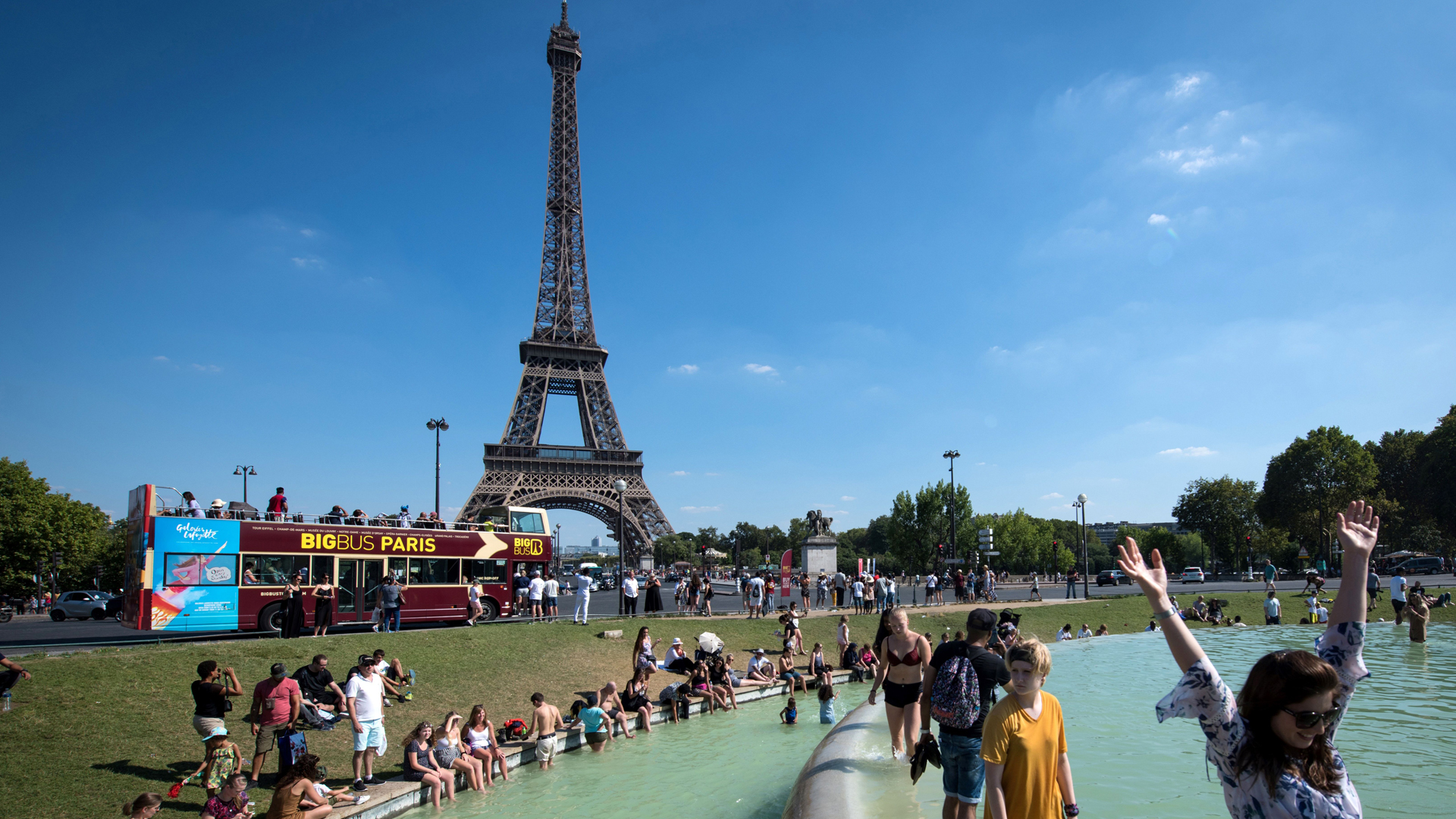 People cool themselves at the Trocadero Fountain in front of The Eiffel Tower in Paris on Aug. 2, 2018. (Credit: Gerard Julien / AFP)