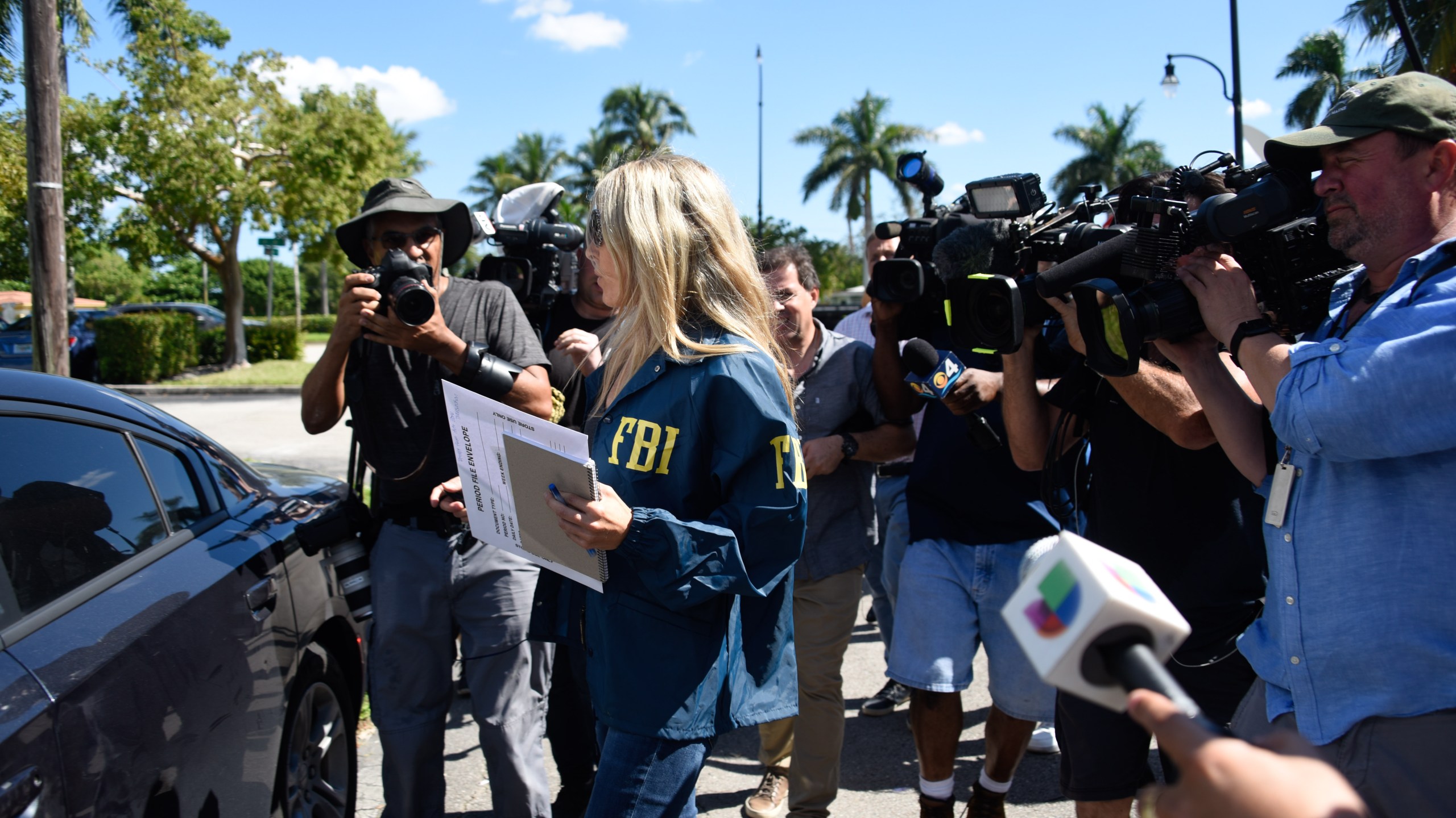 An FBI agent leaves the Auto Zone store in Plantation, north of Miami, on Oct. 26, 2018, where Cesar Sayoc was arrested in connection with 12 pipe bombs and suspicious packages recently mailed to top Democrats. (Credit: MICHELE EVE SANDBERG/AFP/Getty Images)