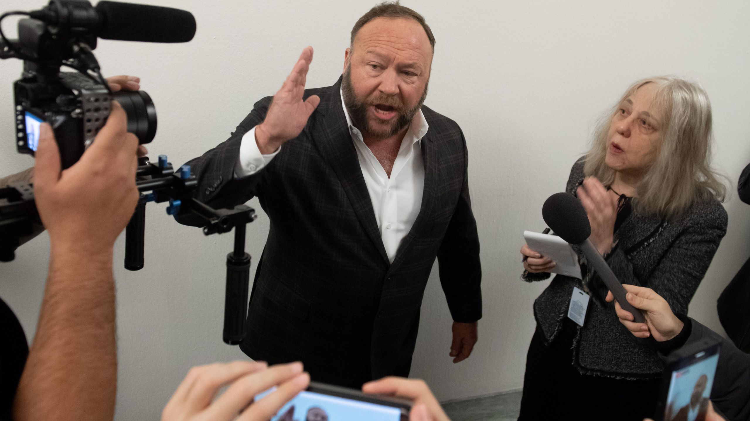 Conservative commentator Alex Jones speaks outside the hearing room prior to testimony by Google CEO Sundar Pichai during a House Judiciary Committee hearing on Capitol Hill, Dec. 11, 2018. (Credit: Saul Loeb / AFP / Getty Images)