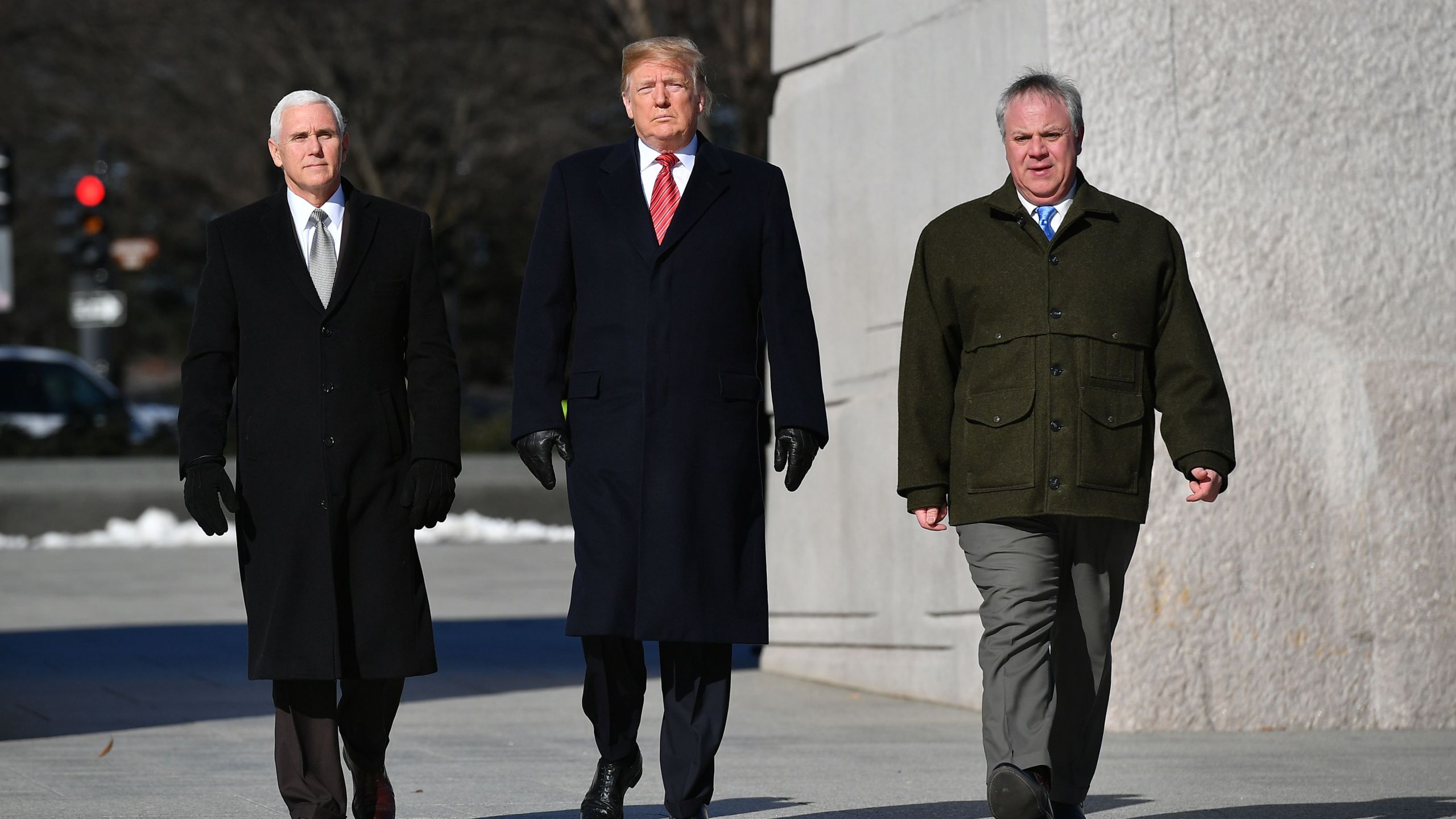 President Donald Trump, Vice President Mike Pence (L) and acting Interior Secretary David Bernhardt visit the Martin Luther King Jr. Memorial in Washington, DC on January 21, 2019 on Martin Luther King Day. (Credit: MANDEL NGAN/AFP/Getty Images)