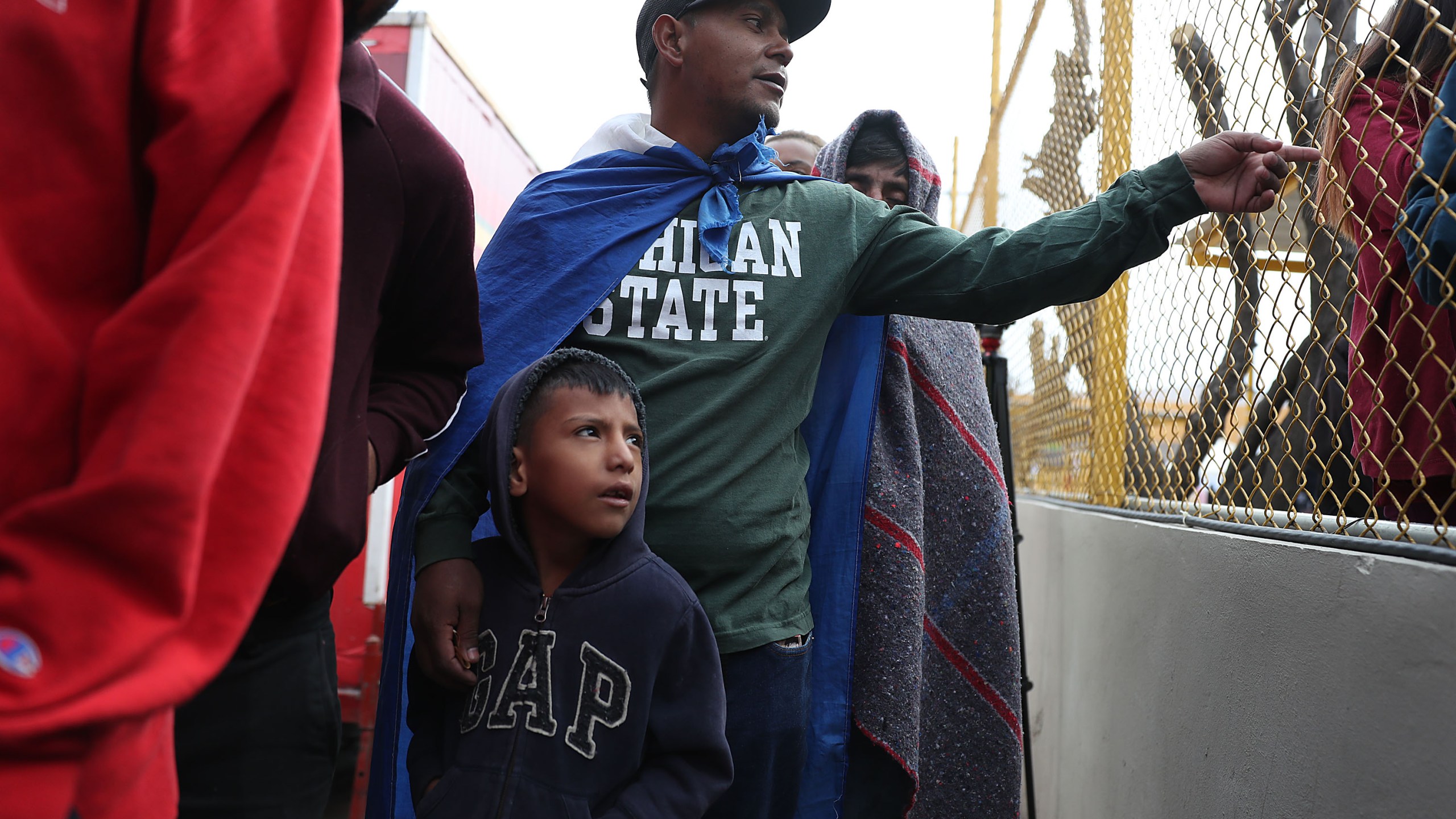 Jose Martinez and his son, Jonathan Martinez, both of whom are from Honduras, join other migrants, most of whom are part of a recently arrived caravan, at a migrant hostel in Piedras Negras, Mexico, as they wait to apply for asylum in to the United States on Feb. 9, 2019. (Credit: Joe Raedle / Getty Images)