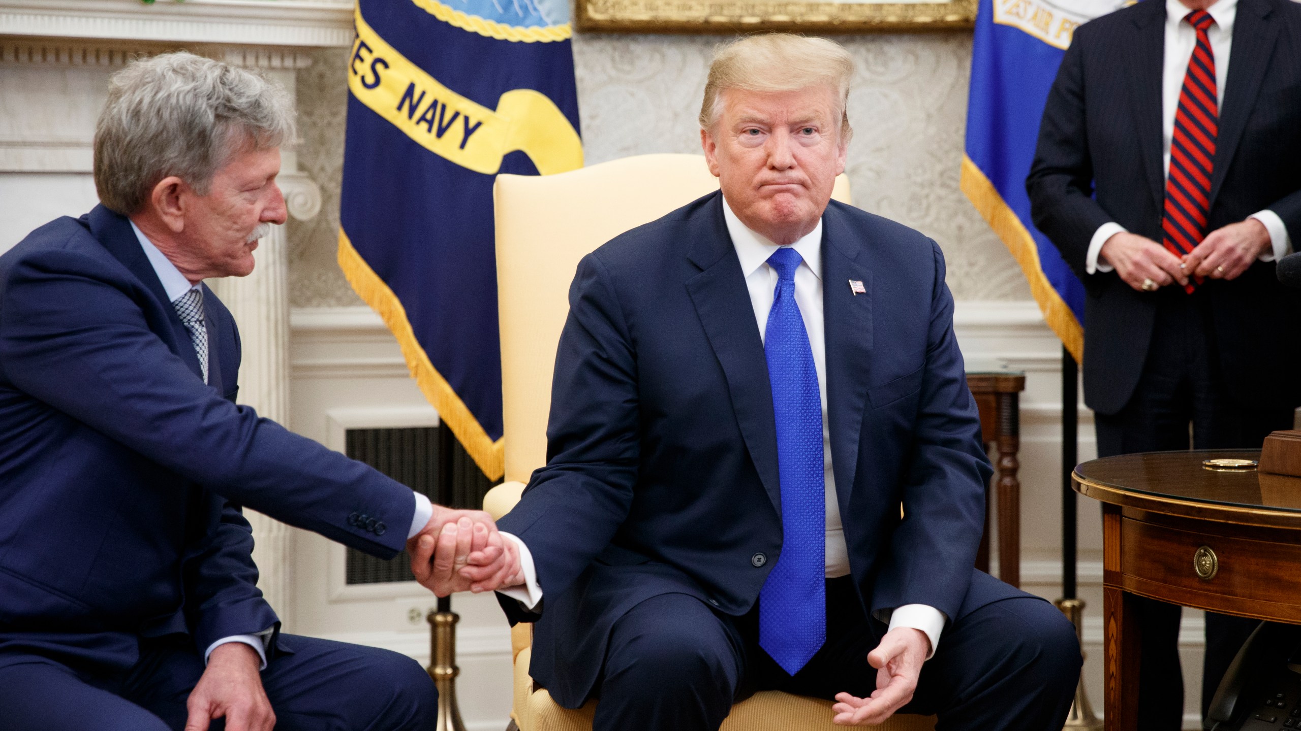 Danny Burch, left, a former U.S. hostage in Yemen, shakes hands with President Donald Trump inside the Oval Office on March 6, 2019. (Credit: Tom Brenner / Getty Images)