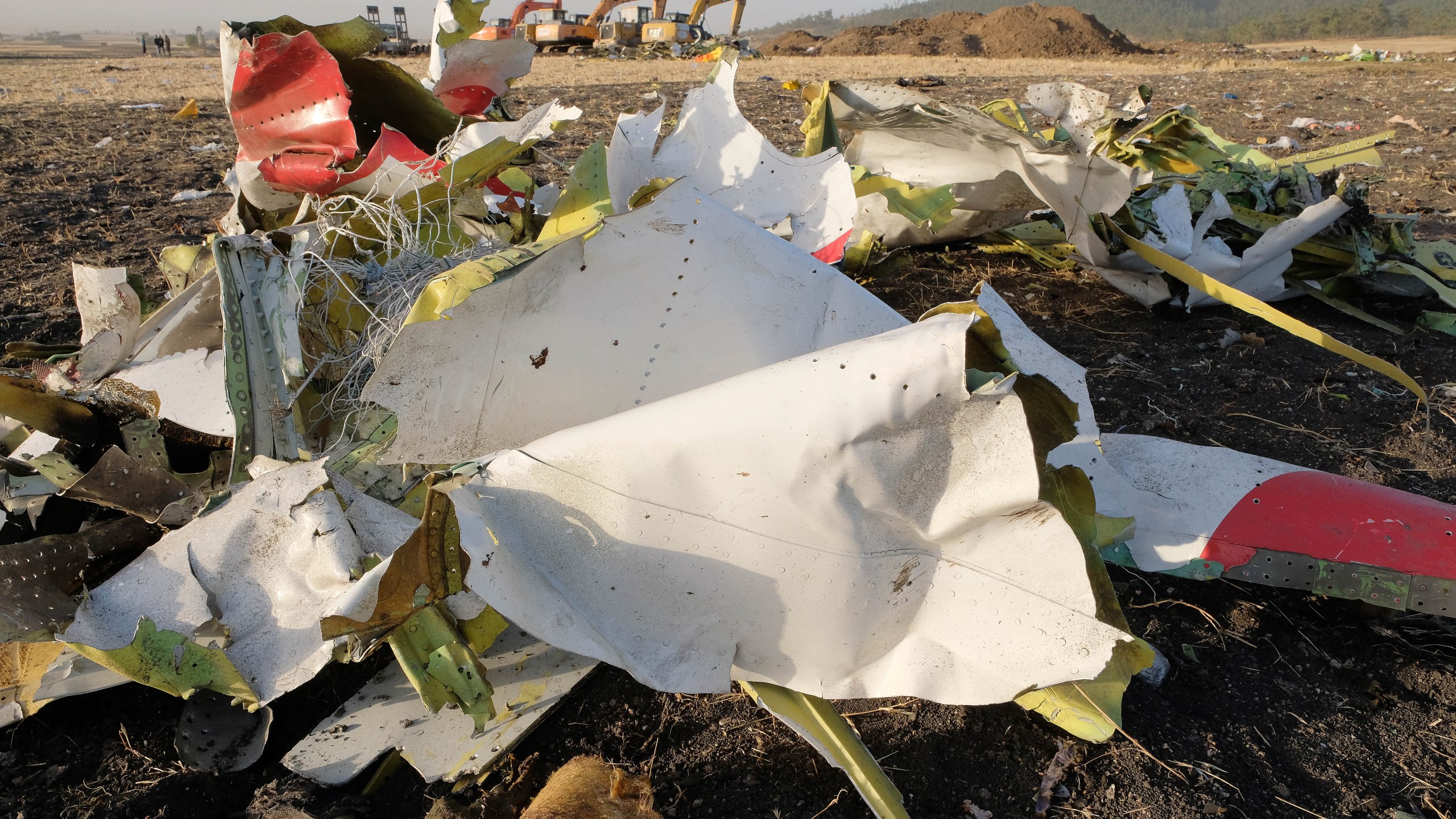 Debris lays piled up just outside the impact crater after being gathered by workers during the continuing recovery efforts at the crash site of Ethiopian Airlines flight ET302 on March 11, 2019 in Bishoftu, Ethiopia. (Credit: Jemal Countess/Getty Images)