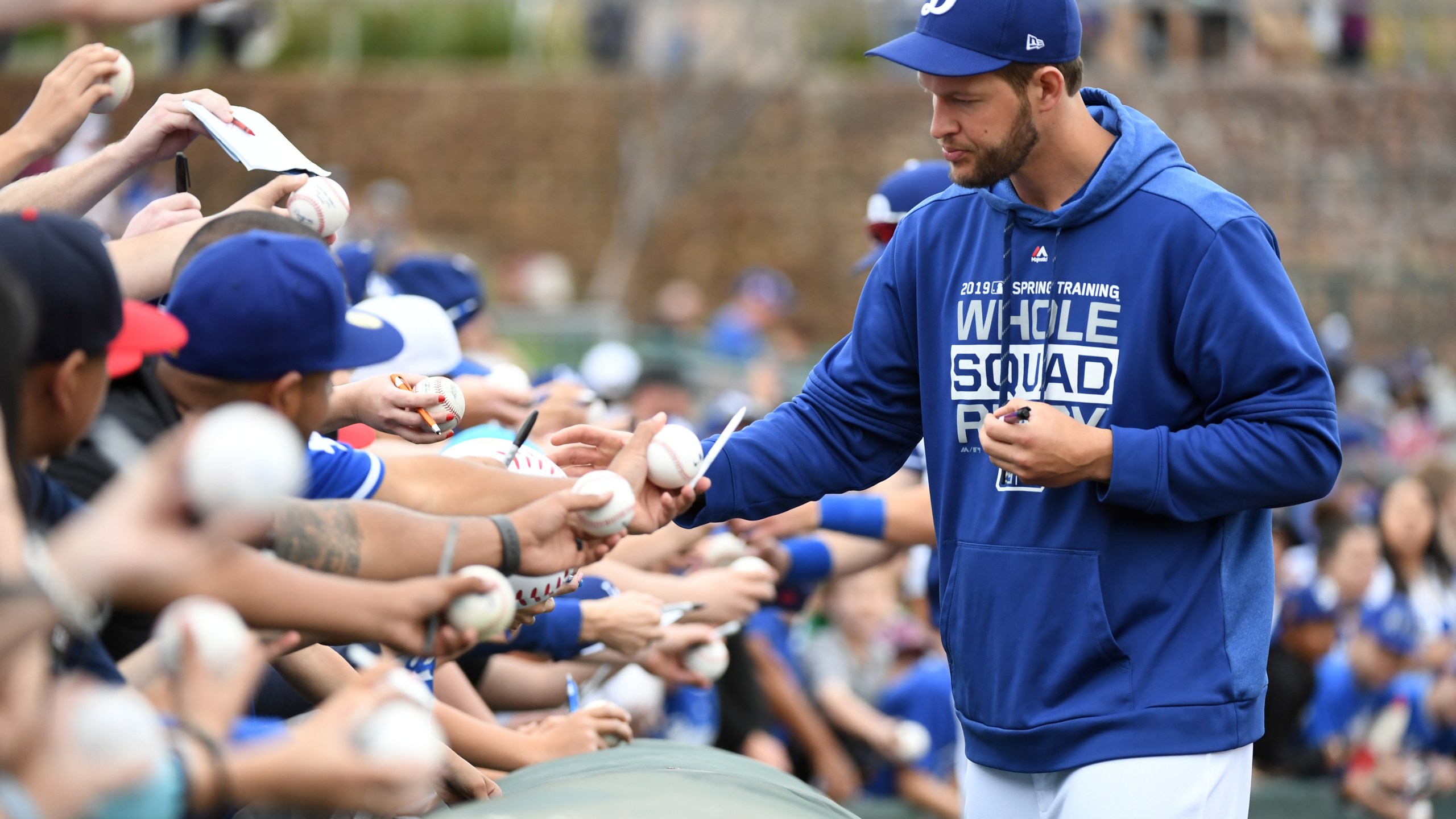 Clayton Kershaw signs autographs before a spring training game against the San Francisco Giants at Camelback Ranch on March 11, 2019 in Glendale, Arizona. (Credit: Norm Hall/Getty Images)