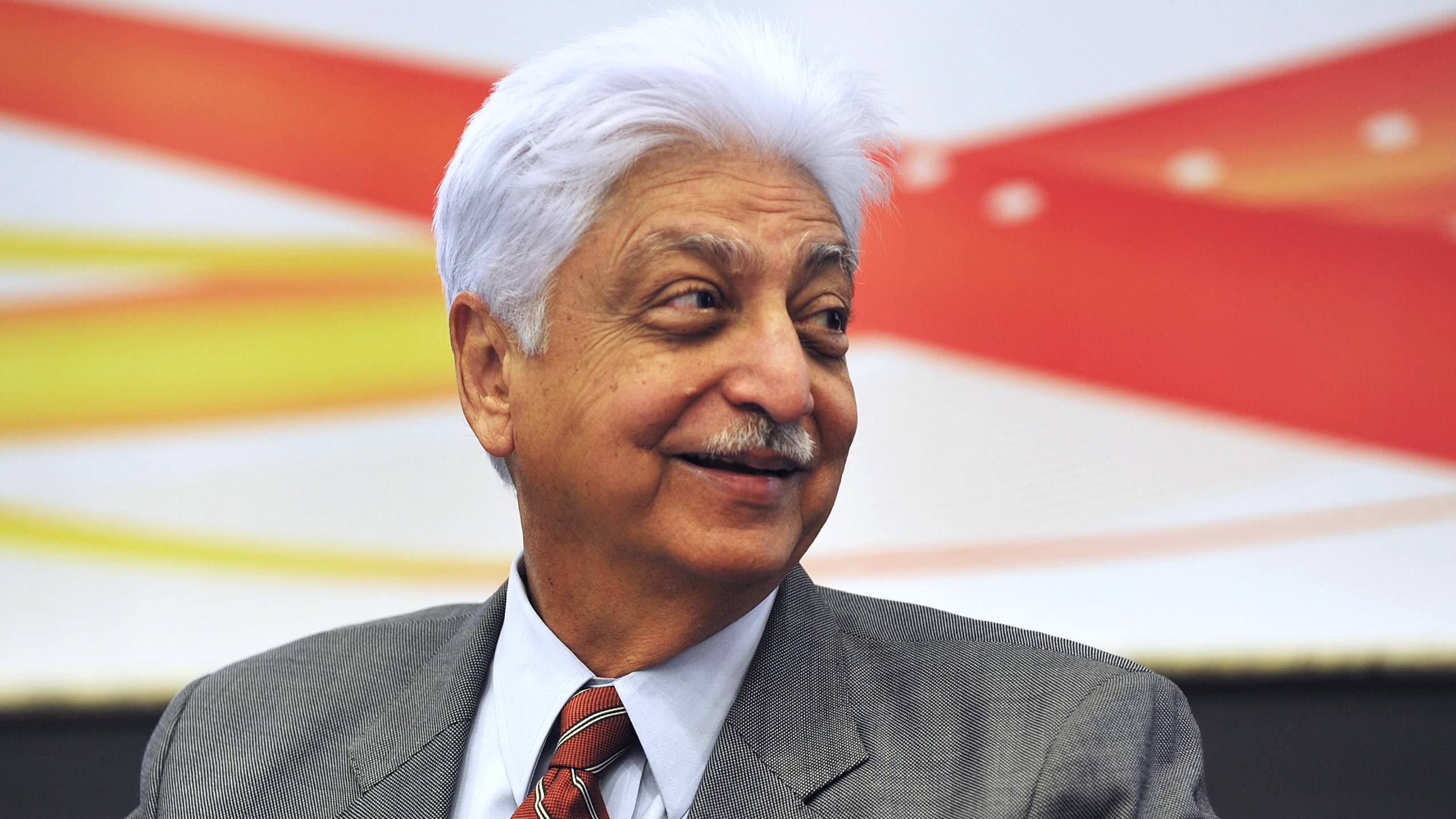 Indian Chairman of Wipro Limited, Azim Premji, smiles during a press conference held to announce the company's 2nd quarter results in Bangalore on November 2, 2012. (Credit: Manjunath Kiran/AFP/Getty Images)