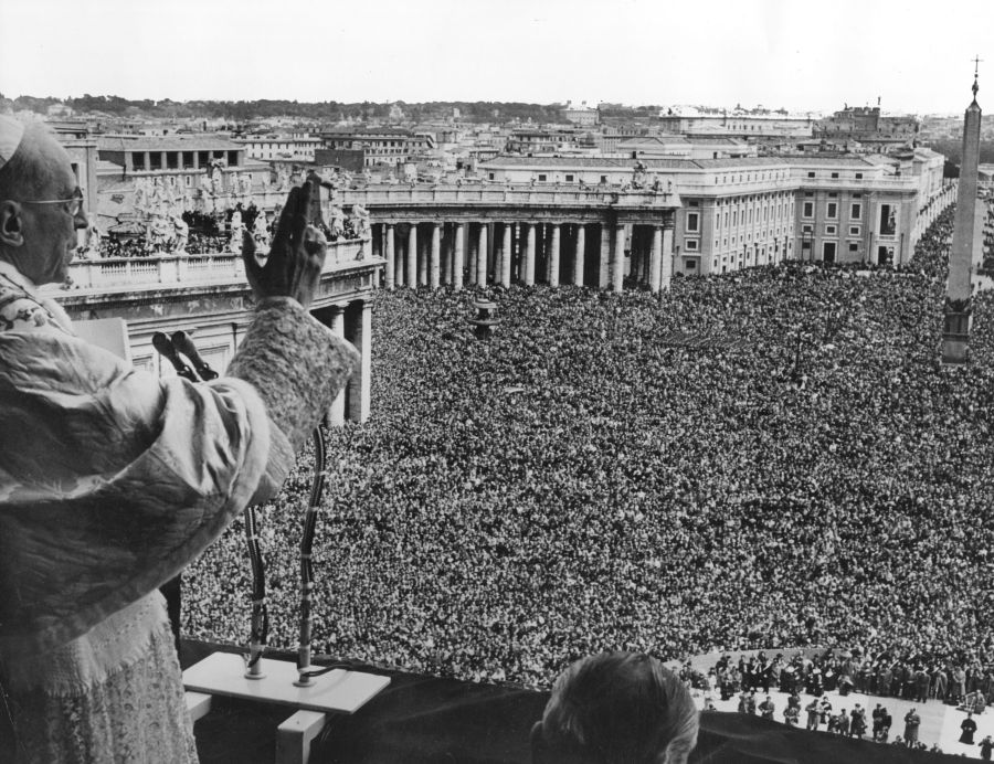 Pope Pius XII blessing the vast crowd gathered in St Peter's Square to witness his appearance on the Vatican balcony. (Credit: Fox Photos/Getty Images)