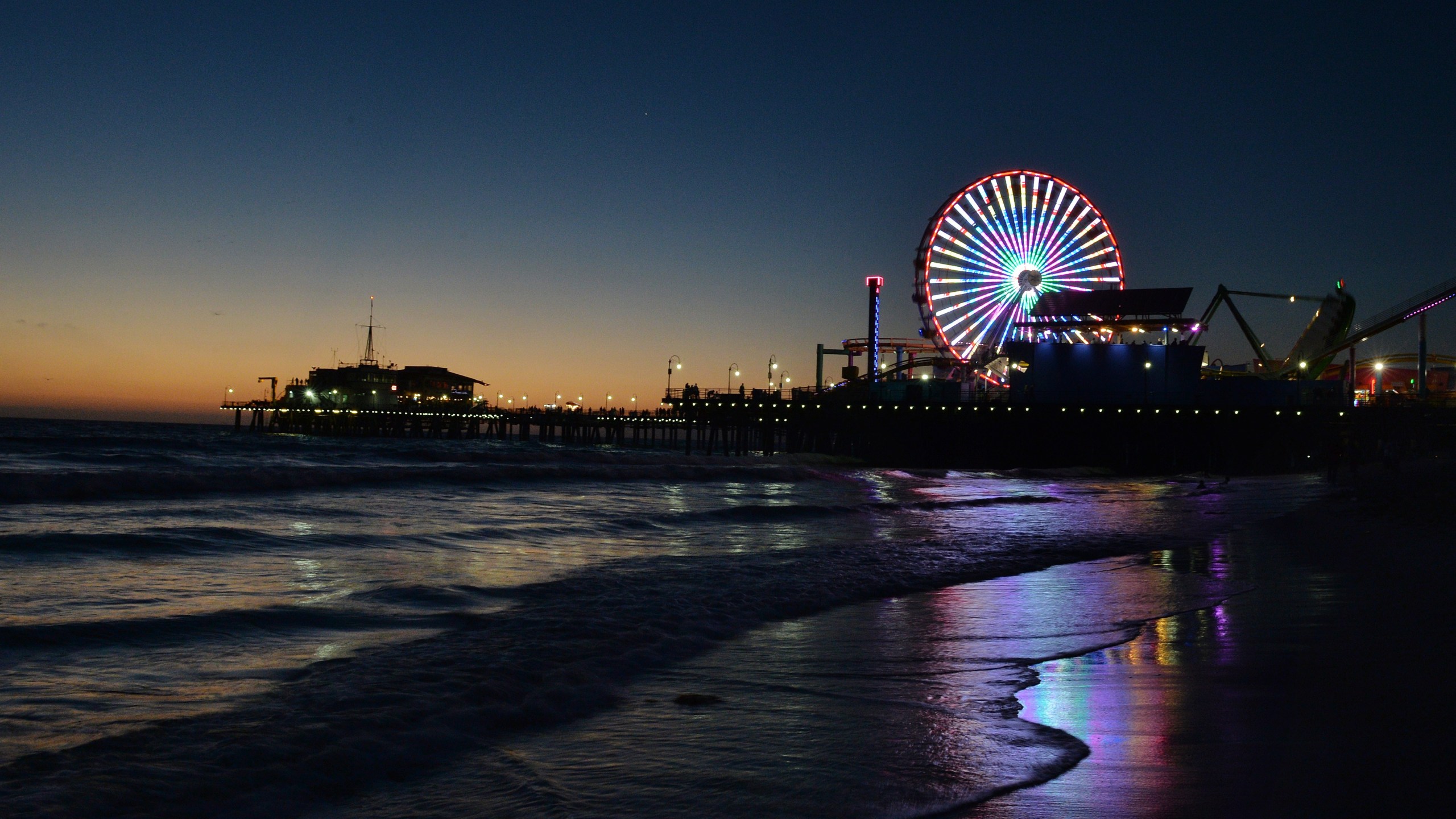 The sun sets over the Pacific Amusement Park at Santa Monica pier on Oct. 19, 2014. (Credit: Mark Ralston/AFP/Getty Images)