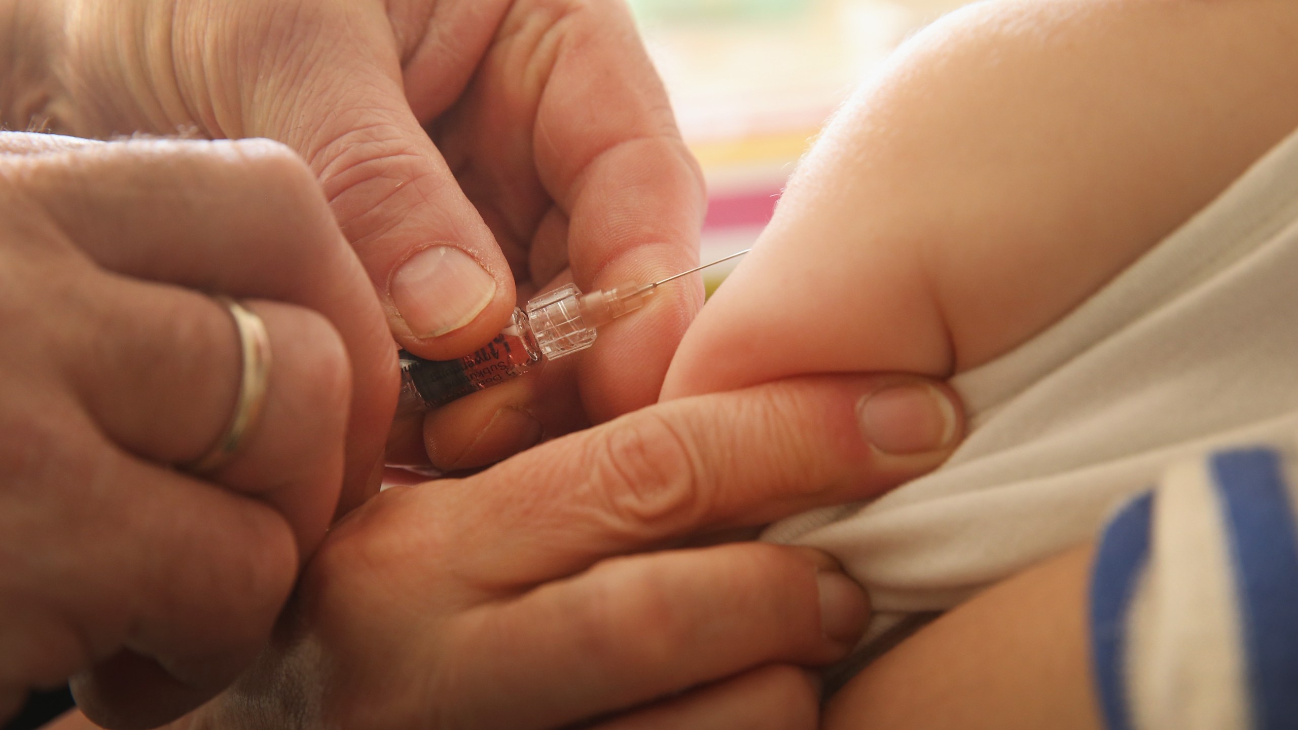 A children's doctor injects a vaccine against measles, rubella, mumps and chicken pox to an infant on Feb. 26, 2015, in Berlin, Germany. (Credit: Sean Gallup/Getty Images)