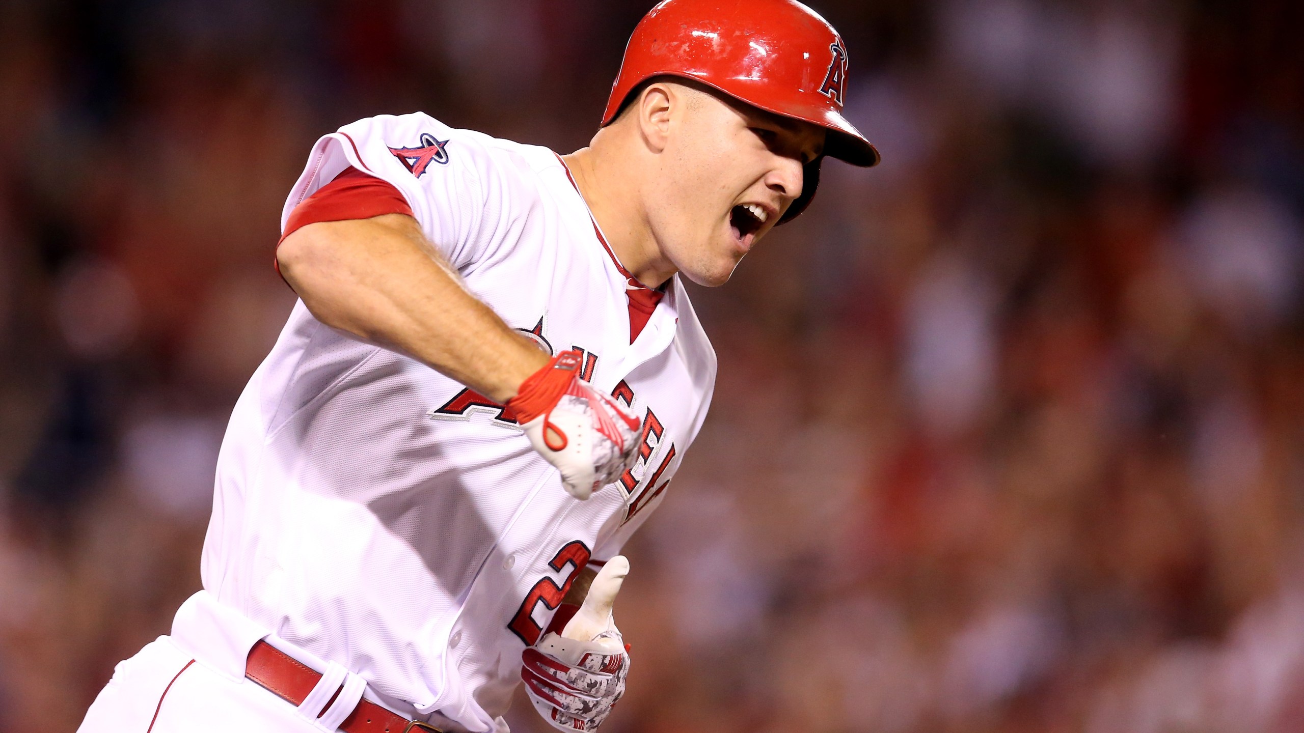 Mike Trout #27 of the Los Angeles Angels of Anaheim reacts as he runs to first as his walk off home run clears the wall in the ninth inning against the Boston Red Sox at Angel Stadium of Anaheim on July 17, 2015 in Anaheim, California. (Credit: Stephen Dunn/Getty Images)