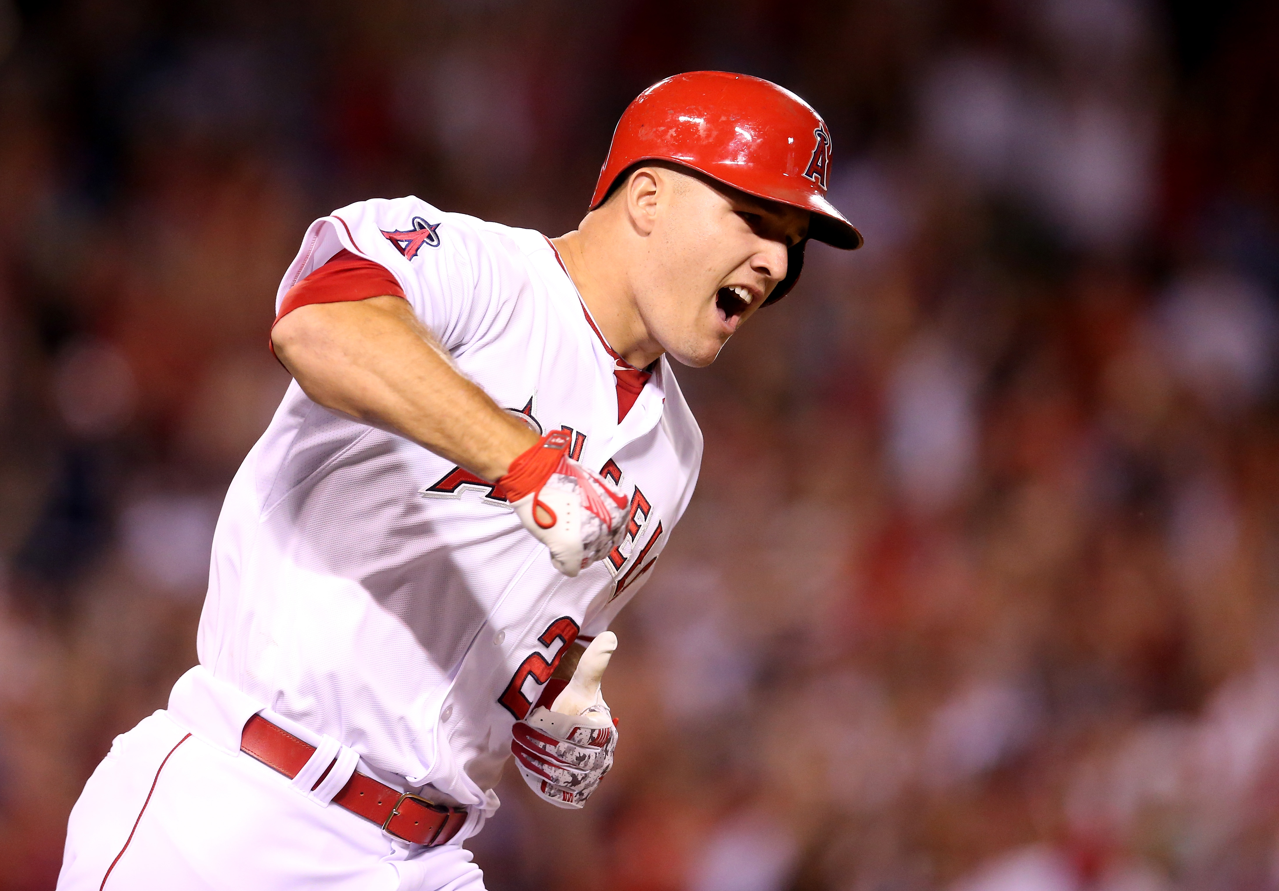 Mike Trout #27 of the Los Angeles Angels of Anaheim reacts as he runs to first as his walk off home run clears the wall in the ninth inning against the Boston Red Sox at Angel Stadium of Anaheim on July 17, 2015 in Anaheim, California. (Credit: Stephen Dunn/Getty Images)