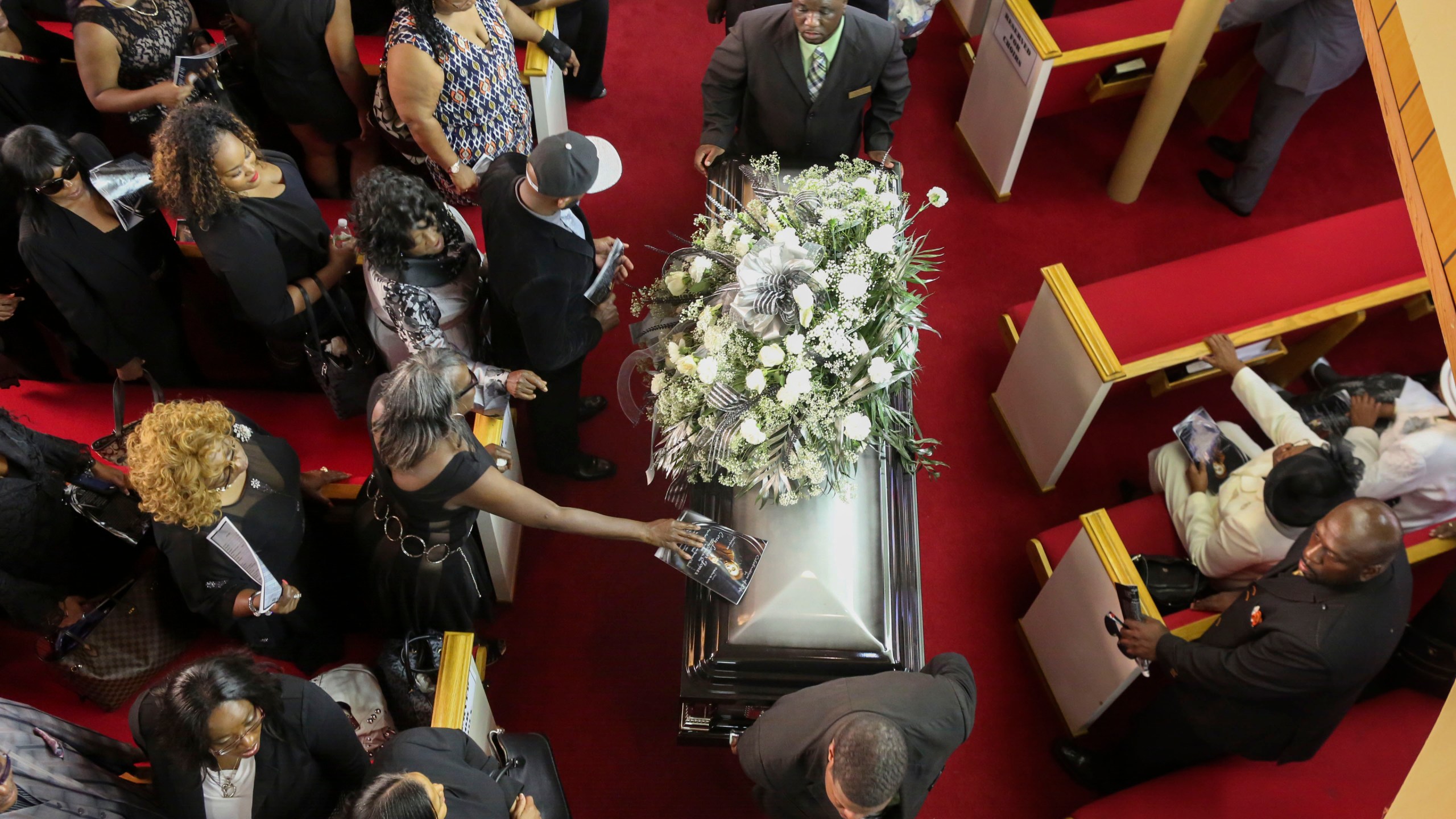 In this handout photo provided by the Palm Beach Post, The casket for Corey Jones is wheeled out of Payne Chapel AME Church following his funeral service October 31, 2015 in West Palm Beach, Florida. (Credit: Damon Higgins-Pool/Getty Images)