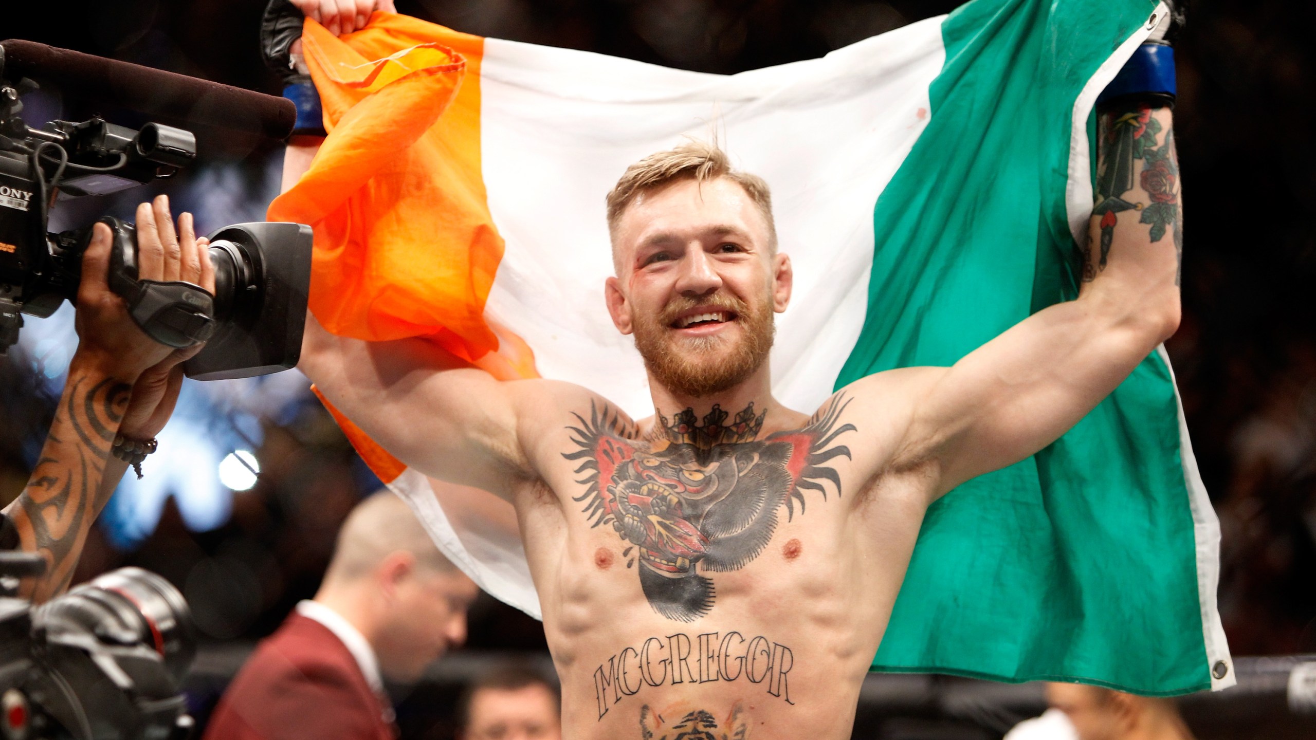 Conor McGregor celebrates after a first-round knockout victory over Jose Aldo in their featherweight title fight during UFC 194 on December 12, 2015 in Las Vegas, Nevada. (Credit: Steve Marcus/Getty Images)