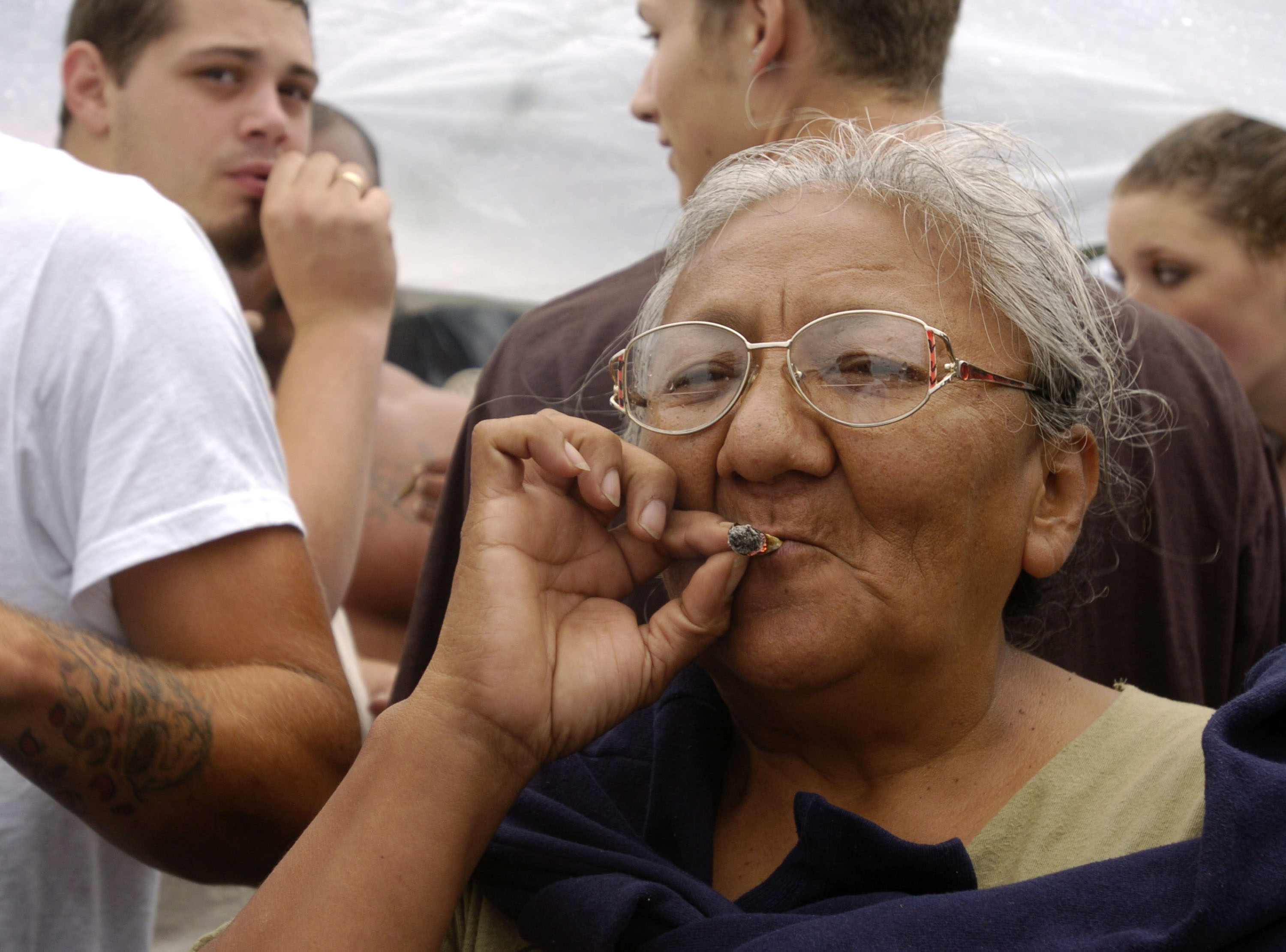 A woman smokes a marijuana joint at Hempfest on Aug. 21, 2004, in Seattle, Washington. (Credit: Ron Wurzer/Getty Images)