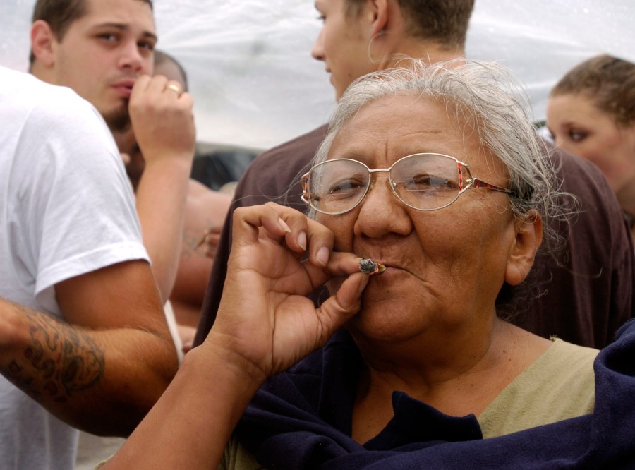 A woman smokes a marijuana joint at Hempfest on Aug. 21, 2004, in Seattle, Washington. (Credit: Ron Wurzer/Getty Images)