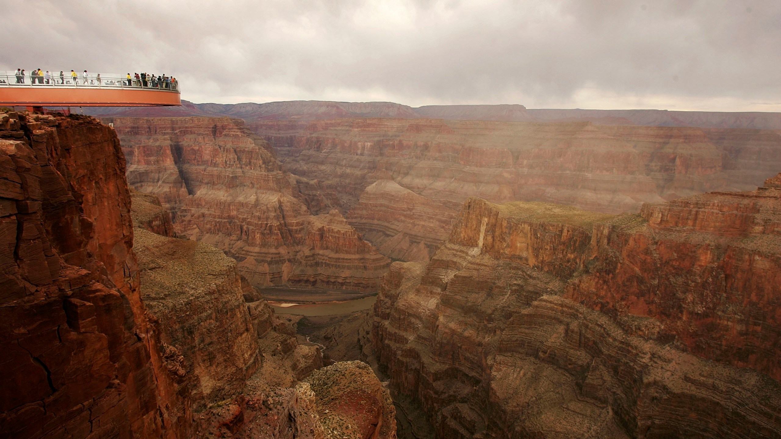 People take the first official walk on the Skywalk, billed as the first-ever cantilever-shaped glass walkway, extending 70 feet from the western Grand Canyon's rim more than 4,000 feet above the Colorado River, on March 20, 2007. (Credit: David McNew / Getty Images)