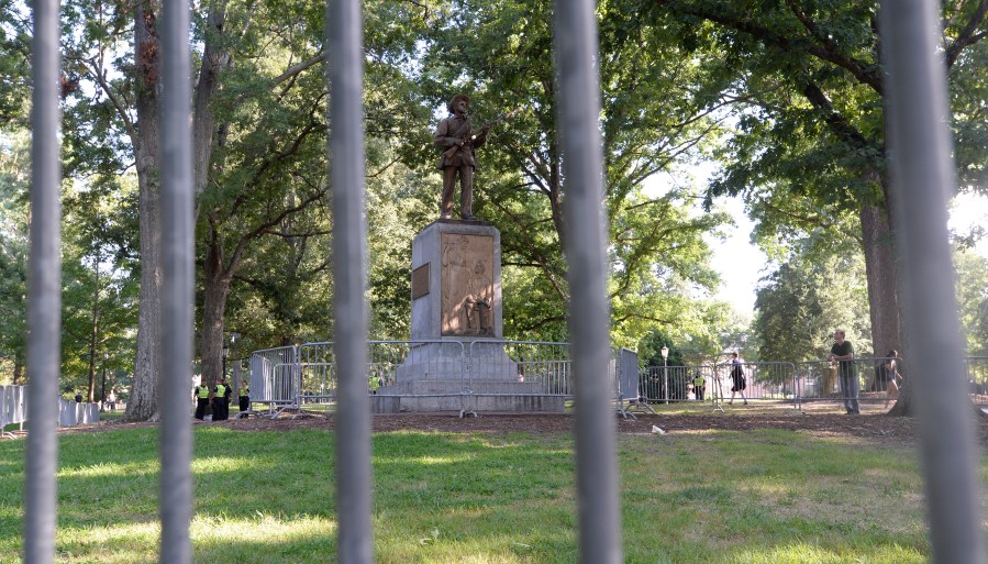 A Confederate statue, coined Silent Sam, is guarded by two layers of fence, chain and police on the campus of the University of North Carolina at Chapel Hill on Aug. 22, 2017. (Credit: Sara D. Davis / Getty Images)