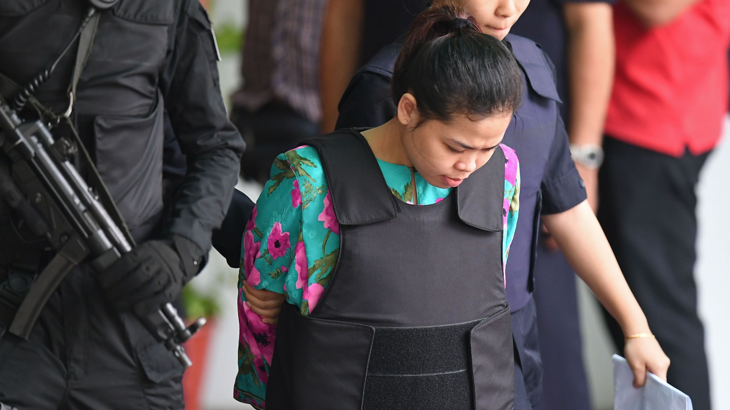 Indonesian defendant Siti Aisyah is escorted by police personnel following her appearance at the Malaysian Chemistry Department in Petaling Jaya, outside Kuala Lumpur on October 9, 2017. (Credit: Mohd Rasfan/AFP/Getty Images)