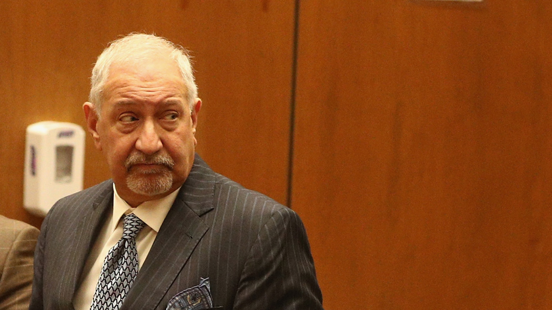 Attorney Mark Geragos stands with his clients during an arraignment hearing at the downtown Los Angeles criminal courts building on March 16, 2018. (Credit: Frederick M. Brown/Getty Images)