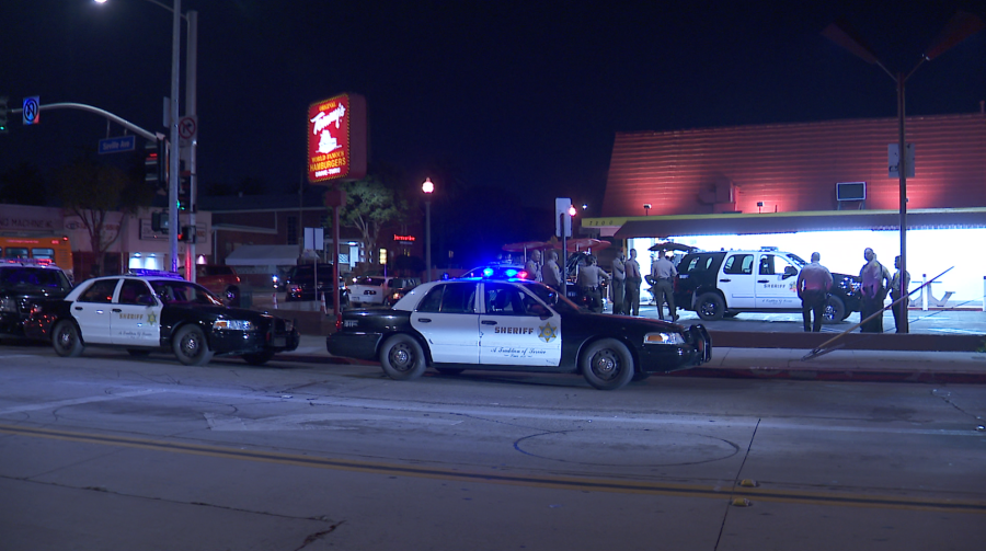 Authorities respond to investigate after deputies shot a woman in a suspicious vehicle in Walnut Park on March 14, 2019. (Credit: KTLA)