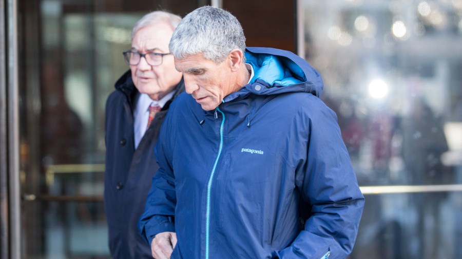 William “Rick” Singer, the Newport Beach consultant accused of leading the scheme, leaves Boston Federal Court after being charged with racketeering conspiracy, money laundering conspiracy, conspiracy to defraud the United States, and obstruction of justice on March 12, 2019, in Boston. Singer is among several charged in alleged college admissions scam. (Credit: Scott Eisen/Getty Images)