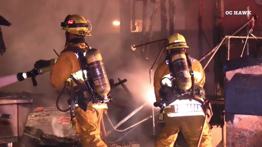 Compton firefighters work to extinguish flames of a home on fire on April 2, 2019. (Credit: OC Hawk)