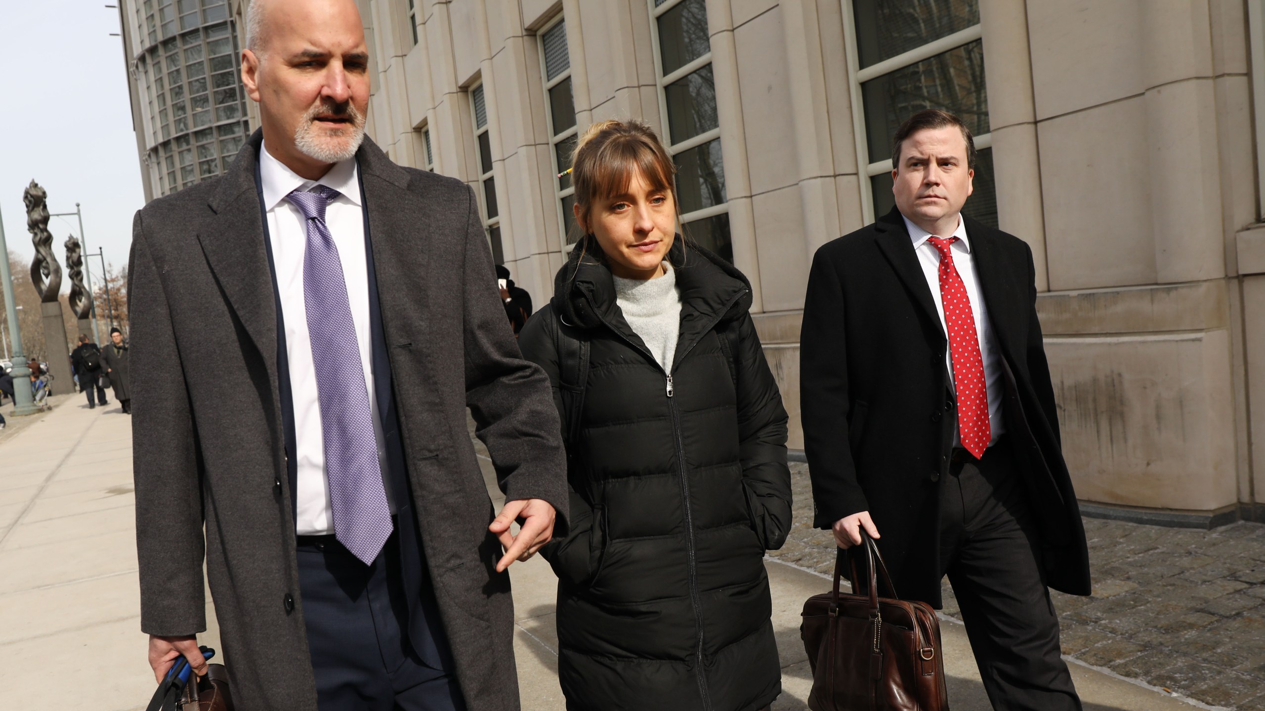 Actress Allison Mack leaves the Brooklyn Federal Courthouse with her lawyers after a court appearance surrounding the alleged sex cult NXIVM on Feb. 6, 2019. (Credit: Spencer Platt / Getty Images)