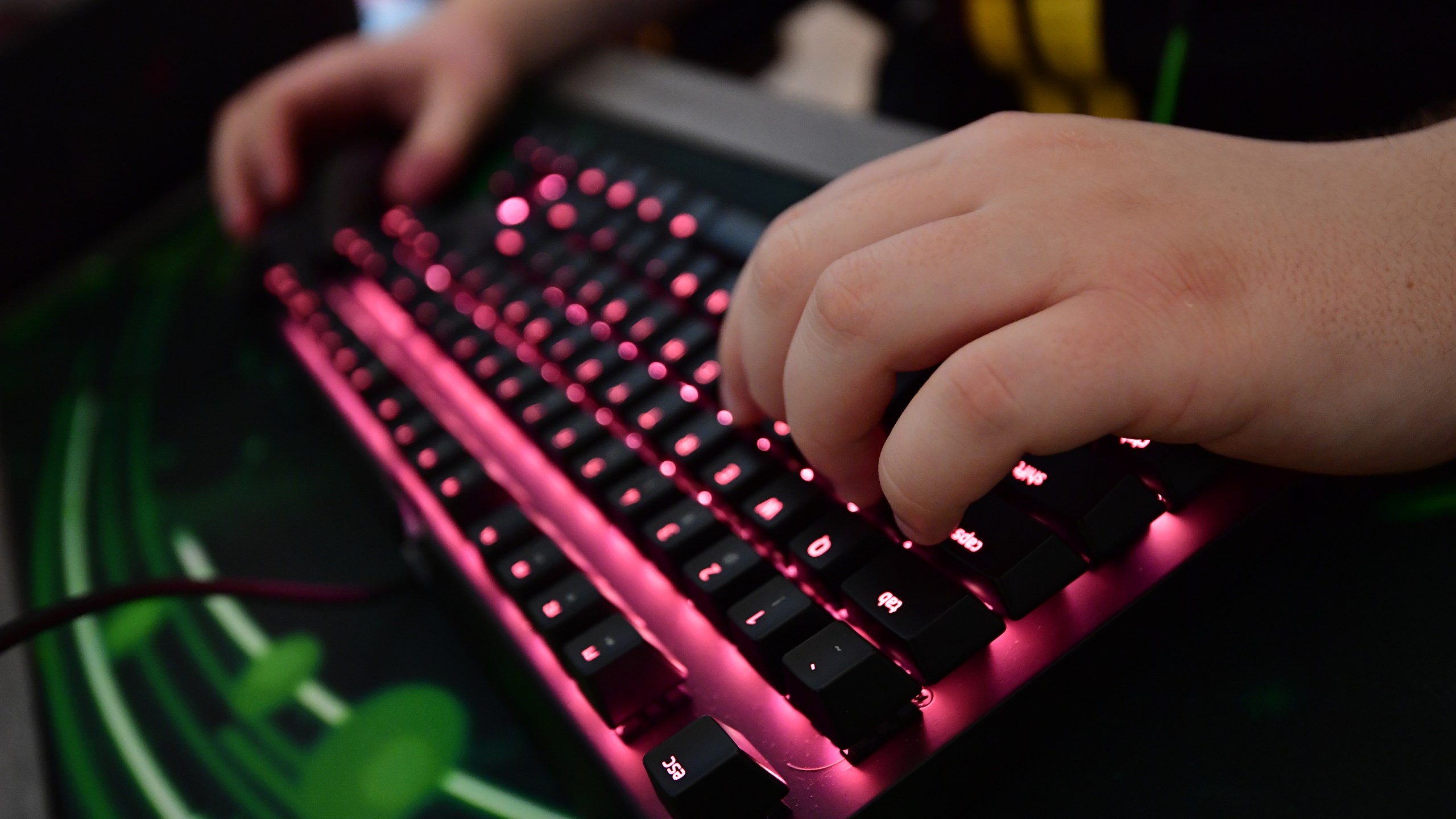 This file photo shows a child using a gaming keyboard. (Credit: Tobias Schwarz/AFP/Getty Images)