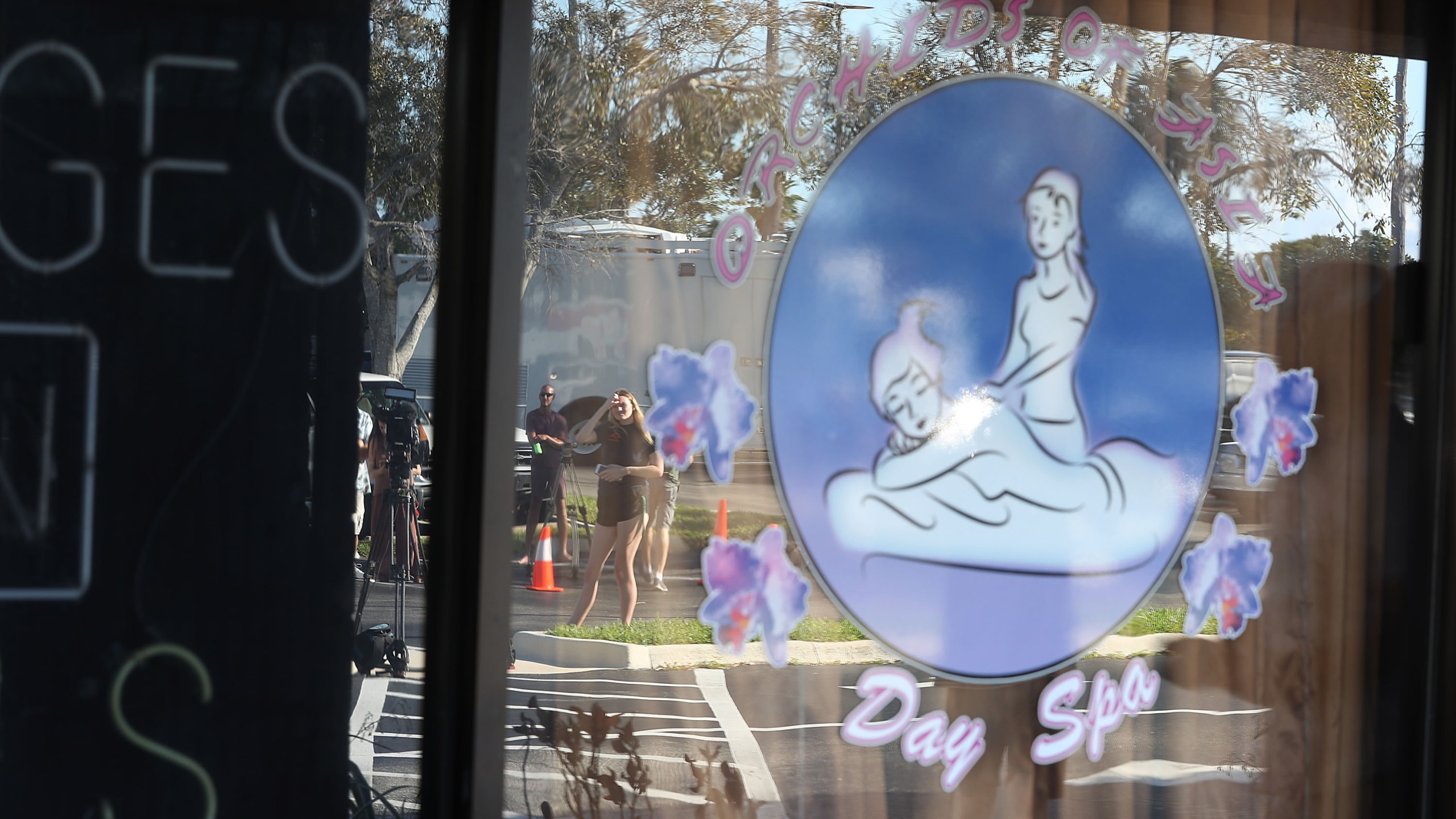 Onlookers and journalists gather outside the Orchids of Asia Day Spa in Jupiter, Florida on Feb. 22, 2019. (Credit: Joe Raedle/Getty Images)