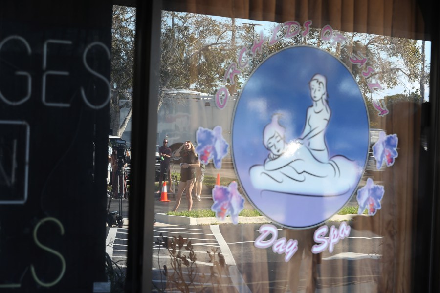 Onlookers and journalists gather outside the Orchids of Asia Day Spa in Jupiter, Florida on Feb. 22, 2019. (Credit: Joe Raedle/Getty Images)