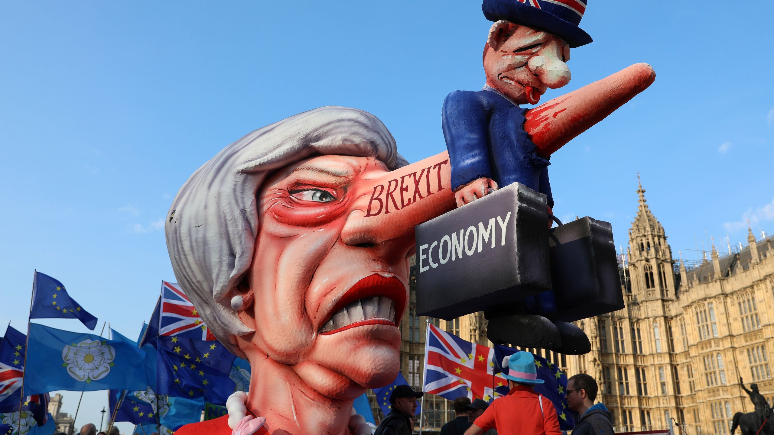 Anti-Brexit activists demonstrate with a model of Theresa May outside the Houses of Parliament in London April 1, 2019. (Credit: Isabel Infantes / AFP / Getty Images)