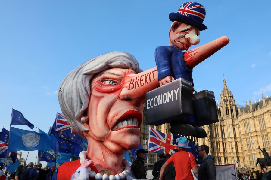 Anti-Brexit activists demonstrate with a model of Theresa May outside the Houses of Parliament in London April 1, 2019. (Credit: Isabel Infantes / AFP / Getty Images)