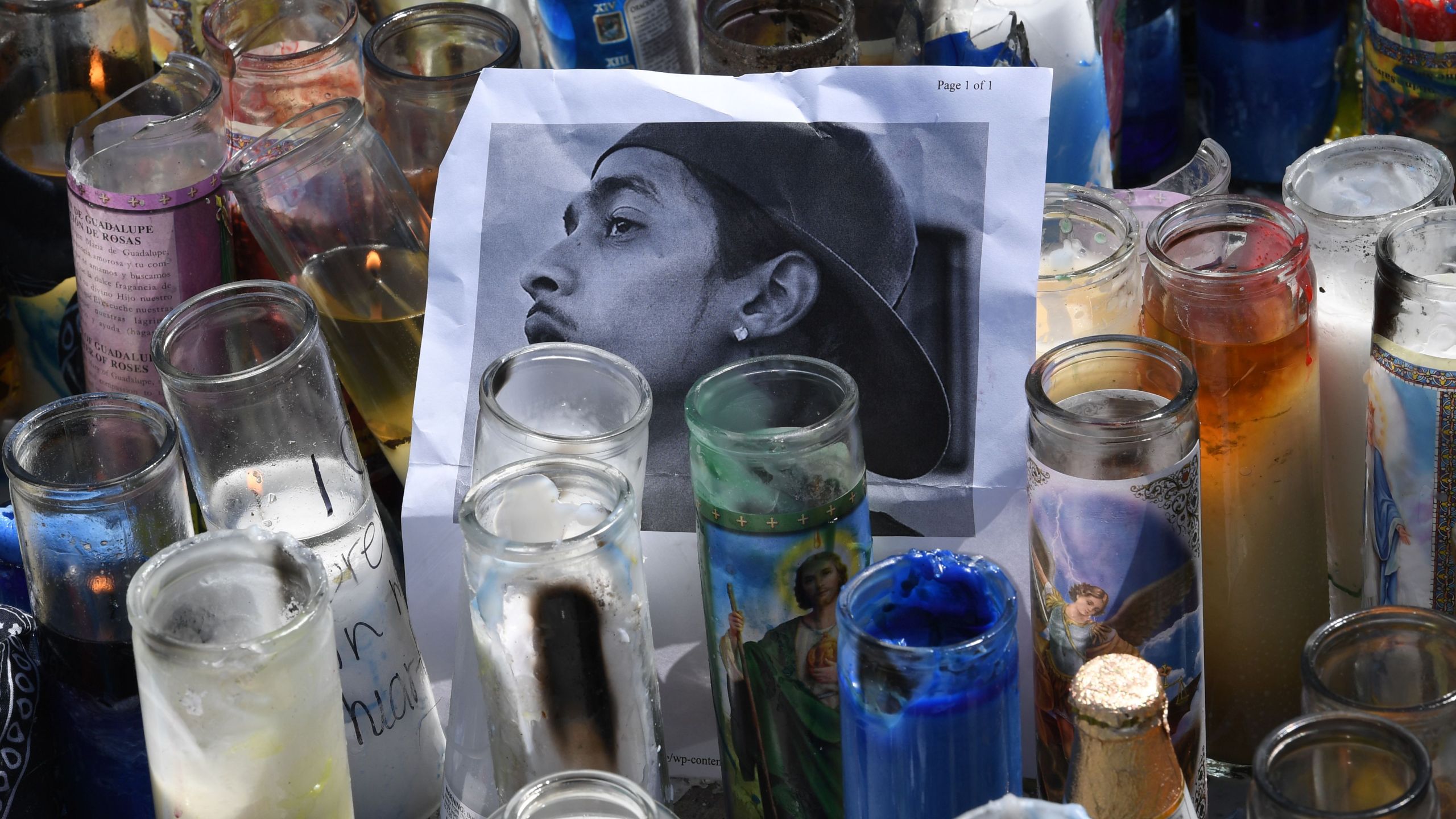 A photo and candles are displayed at a makeshift memorial for Nipsey Hussle on April 1, 2019 outside The Marathon clothing store in South Los Angeles. (Credit: MARK RALSTON/AFP/Getty Images)