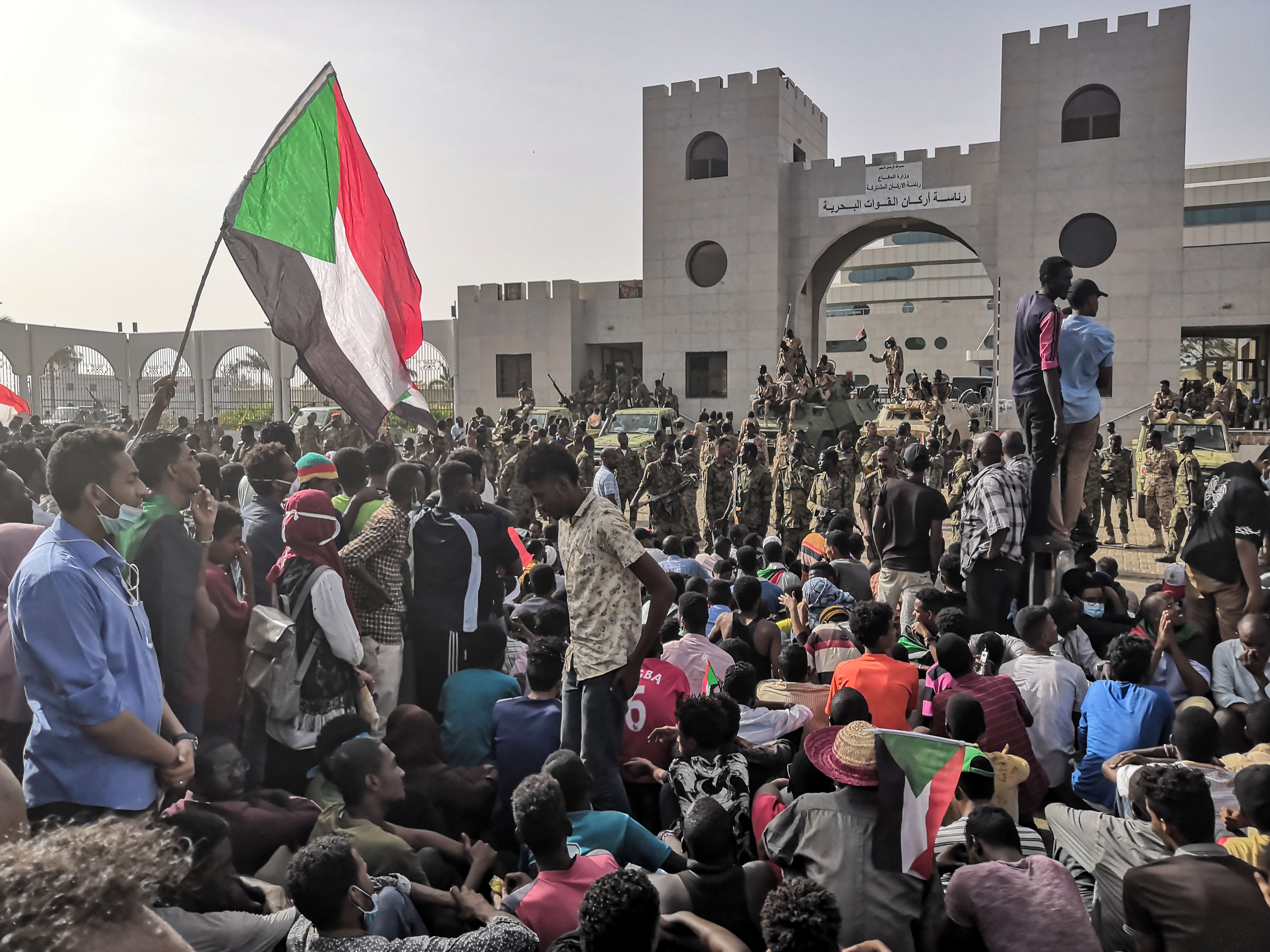 Sudanese soldiers stand guard on armoured military vehicles as demonstrators continue their rally against the regime near the army headquarters in the Sudanese capital Khartoum on April 11, 2019. (Credit: -/AFP/Getty Images)