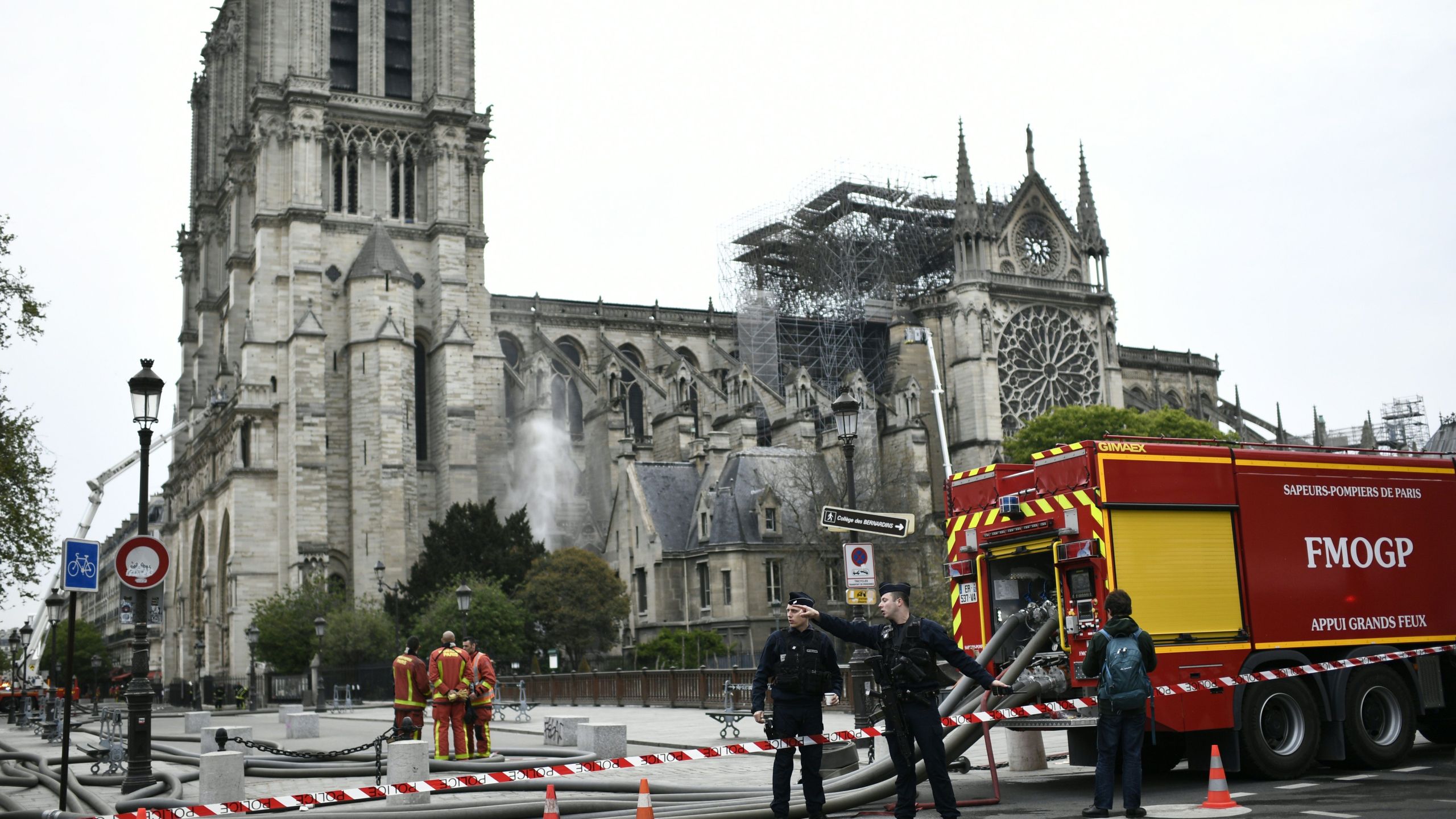 Firefighters continue to secure Notre-Dame Cathedral in Paris on April 16, 2019, in the aftermath of a fire that caused its spire to crash to the ground. (Credit: STEPHANE DE SAKUTIN/AFP/Getty Images)