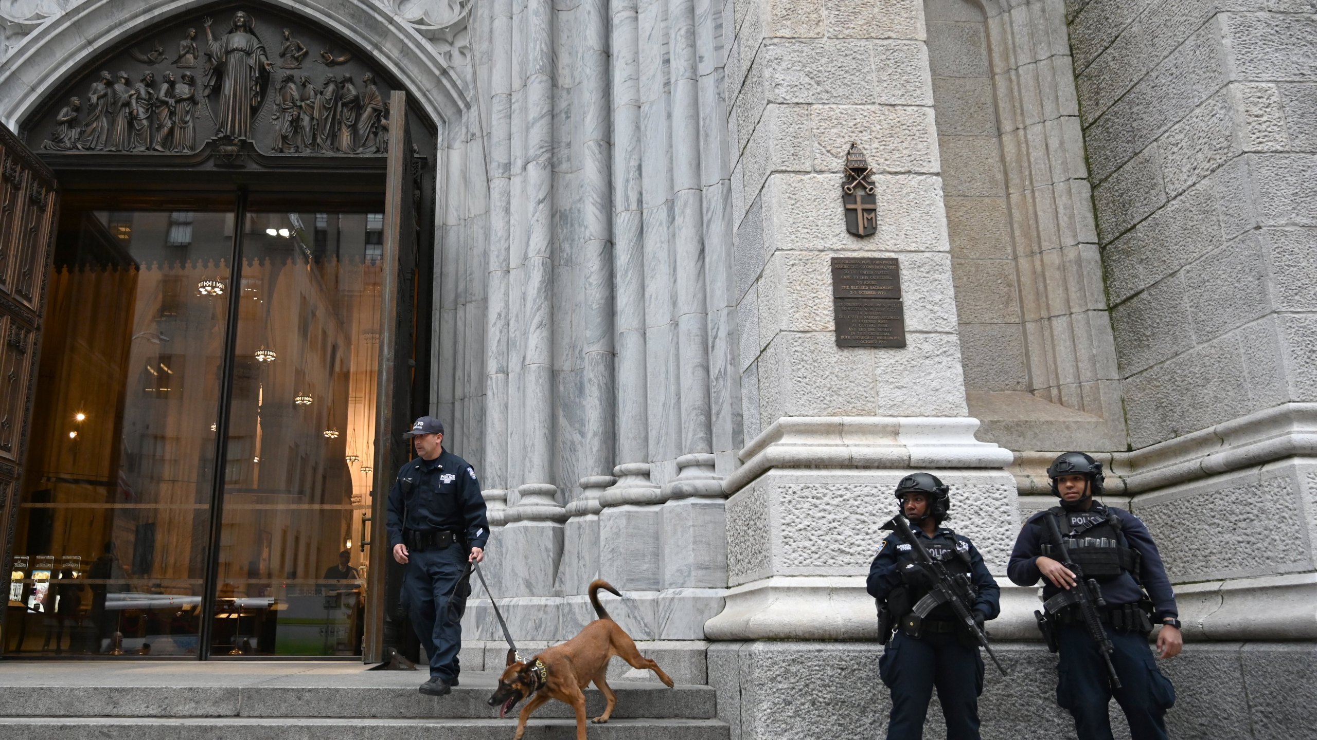 Members of the New York Police Department (NYPD) gather outside St. Patrick's Cathedral on 5th Avenue April 18, 2019, the morning after a man was arrested after trying to enter the Cathedral with gas cans. (Credit: TIMOTHY A. CLARY/AFP/Getty Images)