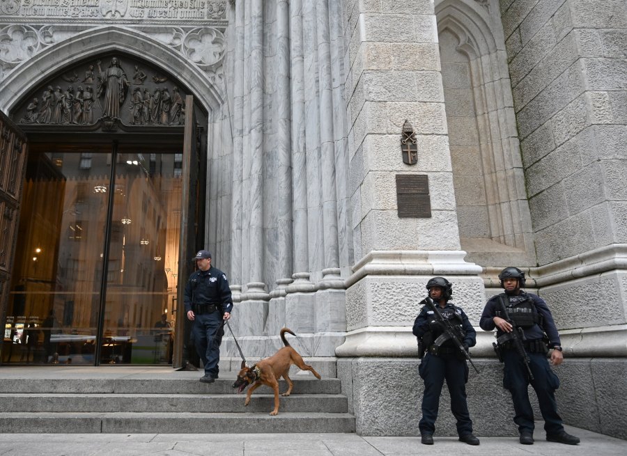 Members of the New York Police Department (NYPD) gather outside St. Patrick's Cathedral on 5th Avenue April 18, 2019, the morning after a man was arrested after trying to enter the Cathedral with gas cans. (Credit: TIMOTHY A. CLARY/AFP/Getty Images)