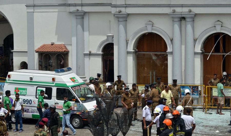 An ambulance is seen outside the church premises with gathered security personnel following a blast at the St. Anthony's Shrine in Kochchikade, Colombo on April 21, 2019. (Credit: Ishara S. Kodikara/AFP/Getty Images)