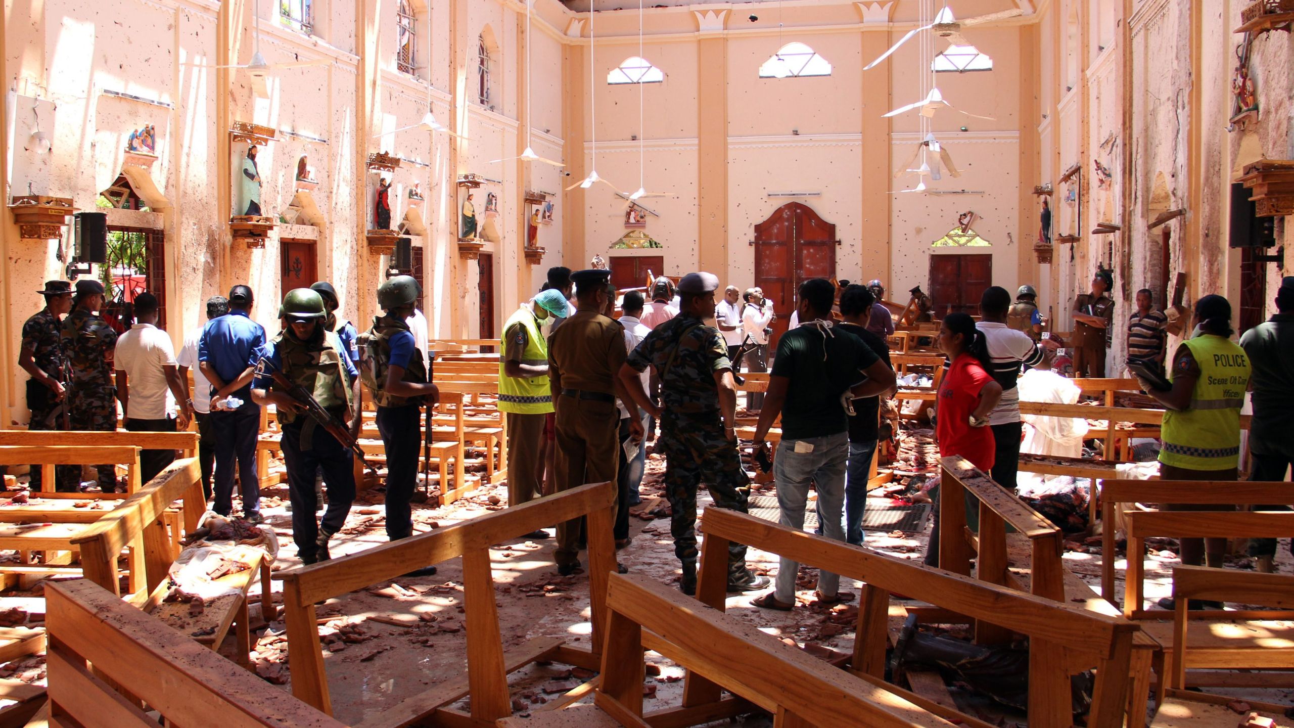 Sri Lankan security personnel walk through debris following an explosion in St. Sebastian's Church in Negombo, north of the capital Colombo, on April 21, 2019. (Credit: STR/AFP/Getty Images)