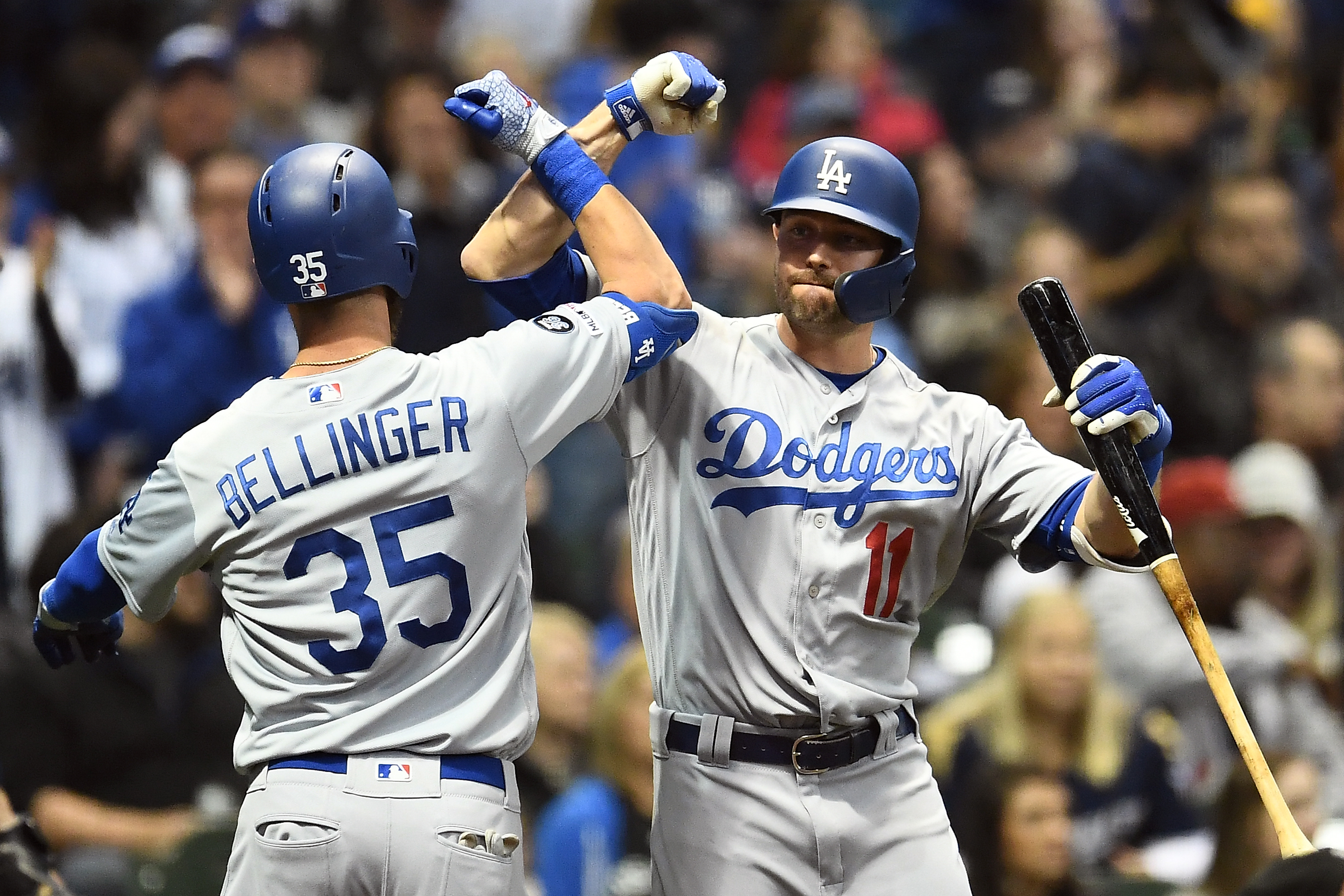 Cody Bellinger #35 of the Los Angeles Dodgers is congratulated by A.J. Pollock #11 following a solo home run against the Milwaukee Brewers during the sixth inning at Miller Park on April 18, 2019 in Milwaukee, Wisconsin. (Credit: Stacy Revere/Getty Images)