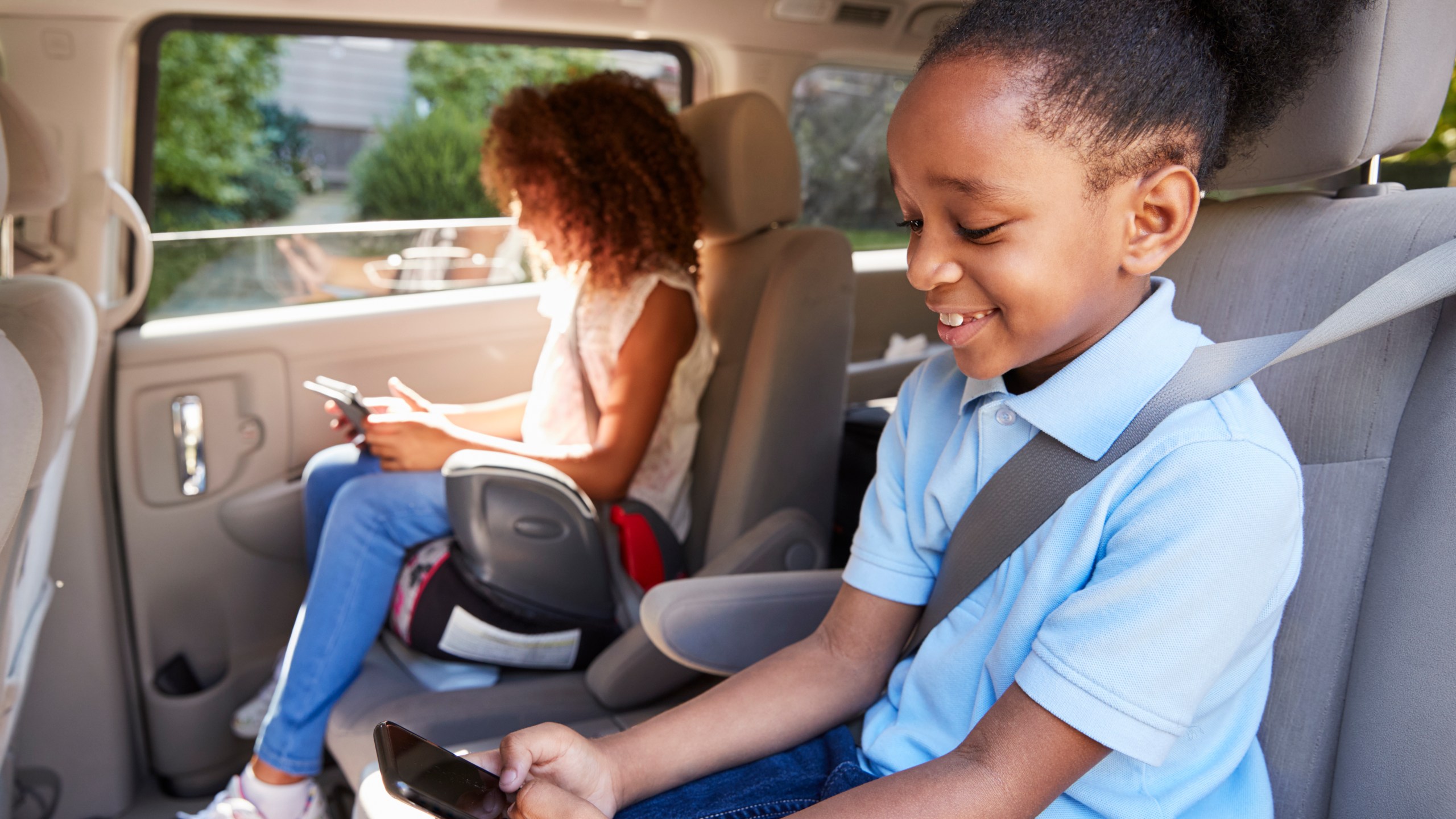 Children are seen in a booster seat in this file photo. (Credit: iStock / Getty Images Plus)