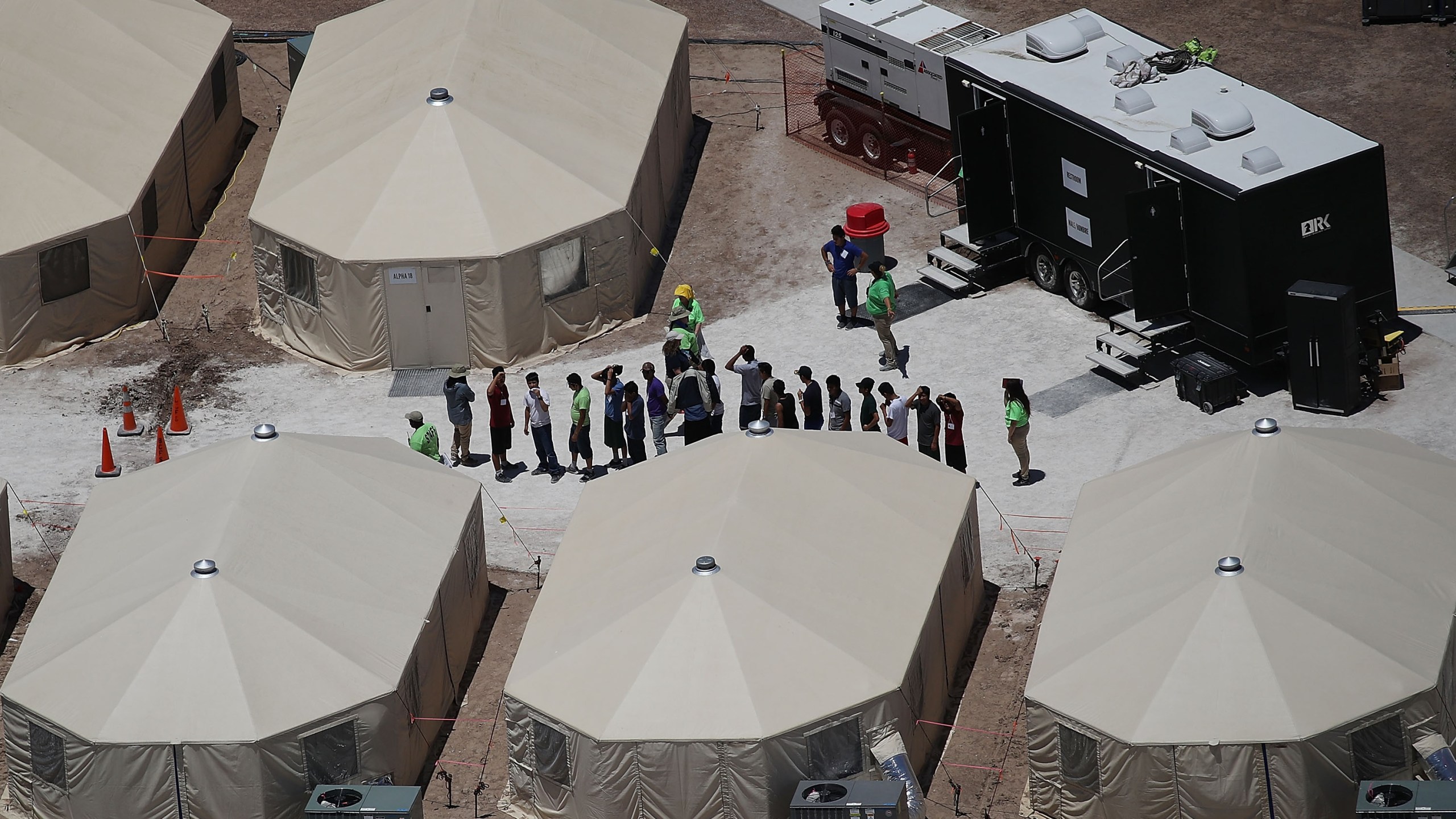 Children and workers are seen at a tent encampment built near the Tornillo Port of Entry on June 19, 2018 in Tornillo, Texas. (Credit: Joe Raedle/Getty Images)