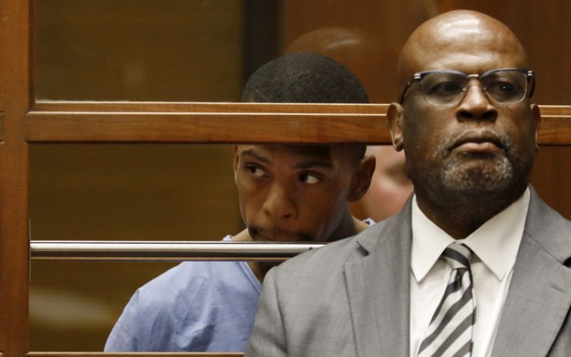 Eric Holder, left, appears in a downtown Los Angeles courtroom on April 4, 2019. At right is his attorney Chris Darden. (Credit: Francine Orr / Los Angeles Times)