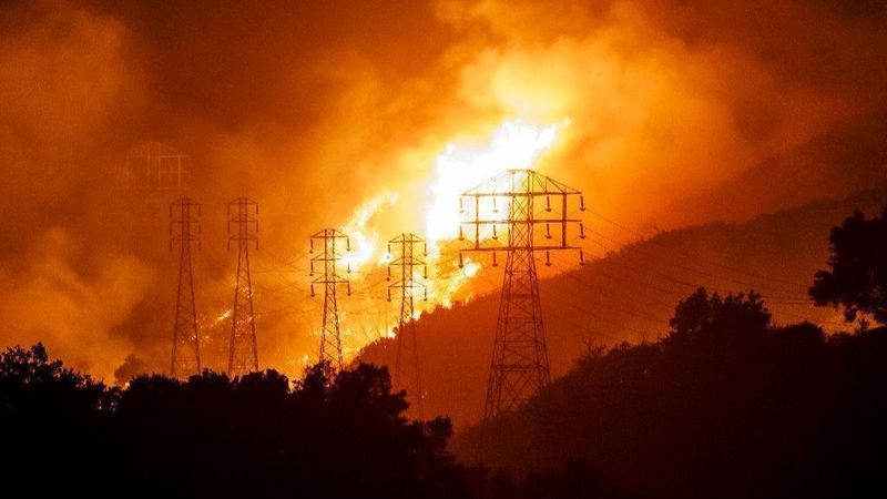 Flames from the Thomas fire whip around utility power lines in Sycamore Canyon on Dec. 16, 2017. (Credit: Marcus Yam / Los Angeles Times)