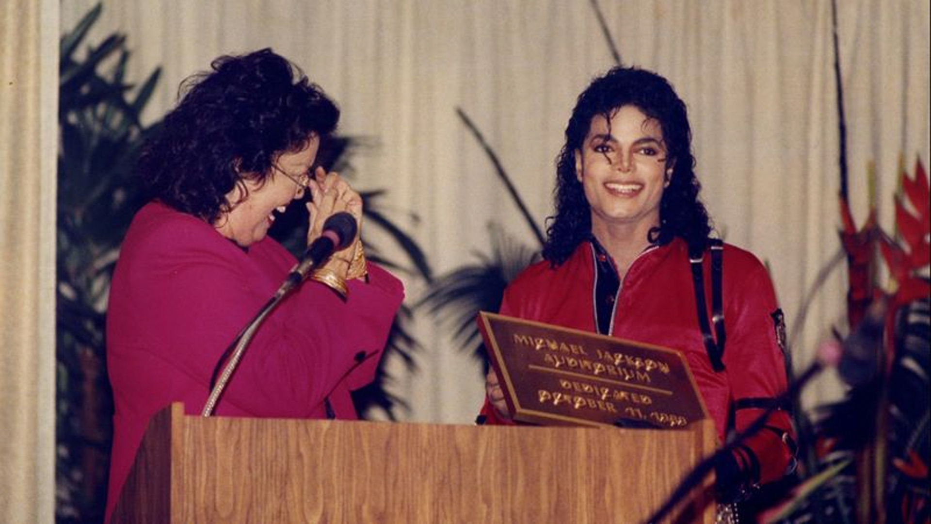 An L.A. school that honored Michael Jackson may remove his name from its auditorium. In this photo from 1989, Jackson reunites with sixth-grade teacher Laura Gerson during the naming ceremony at Gardner Elementary. (Credit: Los Angeles Times)